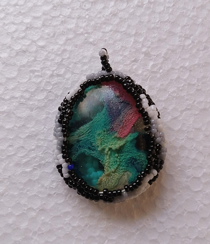 Black and white algae windmill beaded pendant