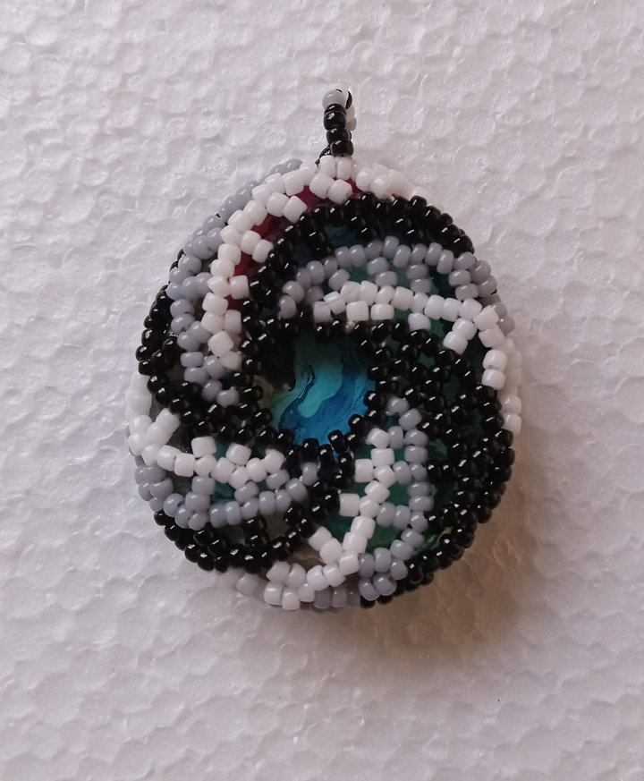 Black and white algae windmill beaded pendant