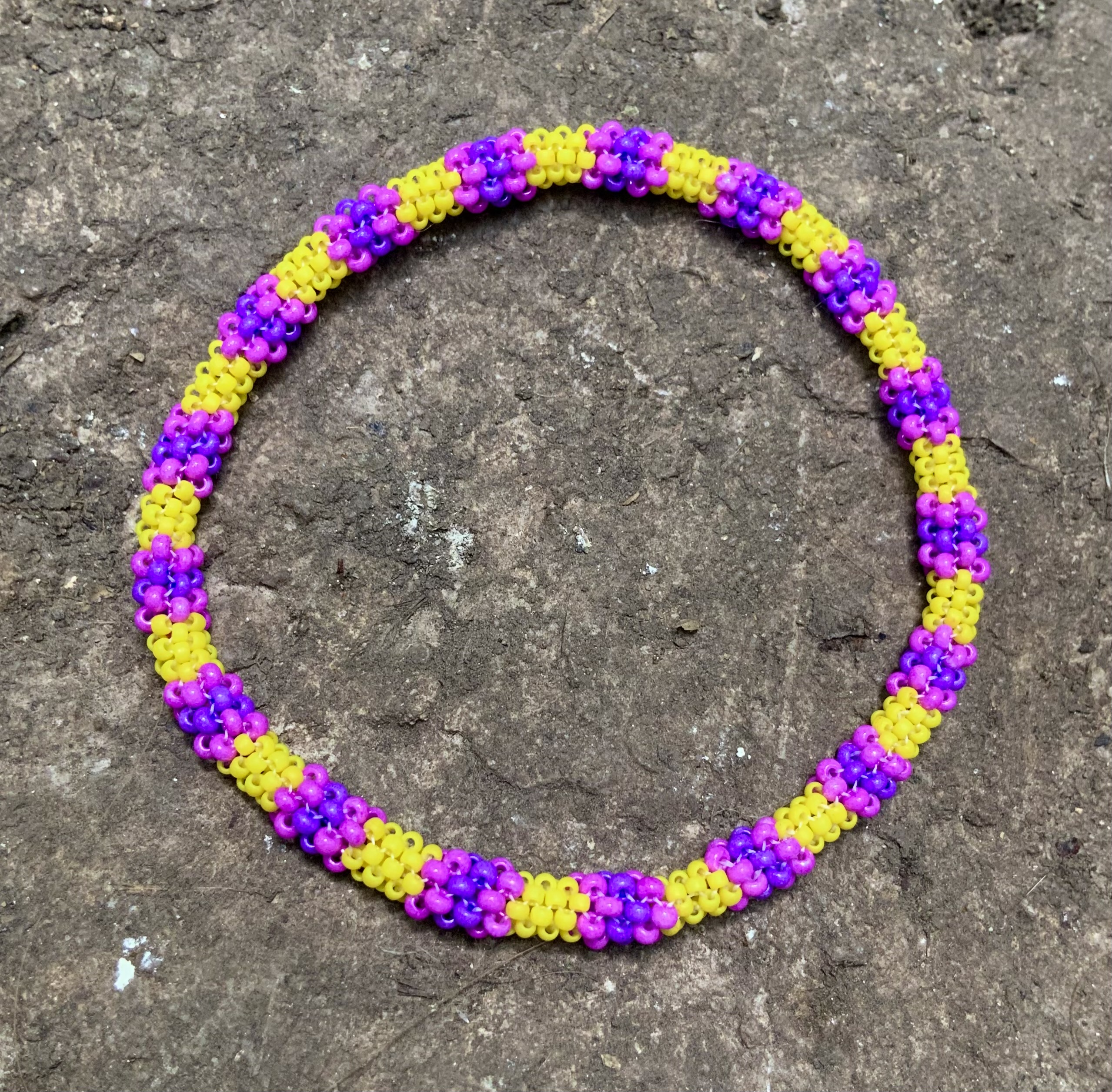 Yellow and purple beaded infinity bracelet