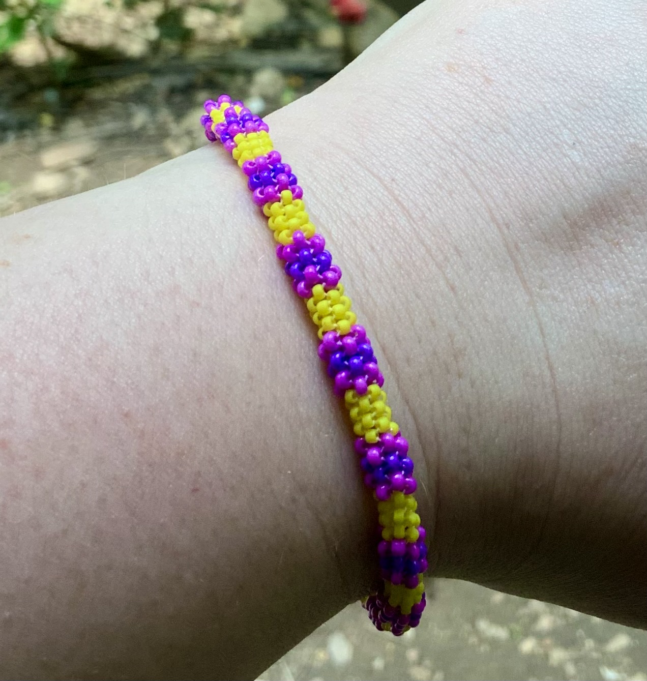 Yellow and purple beaded infinity bracelet