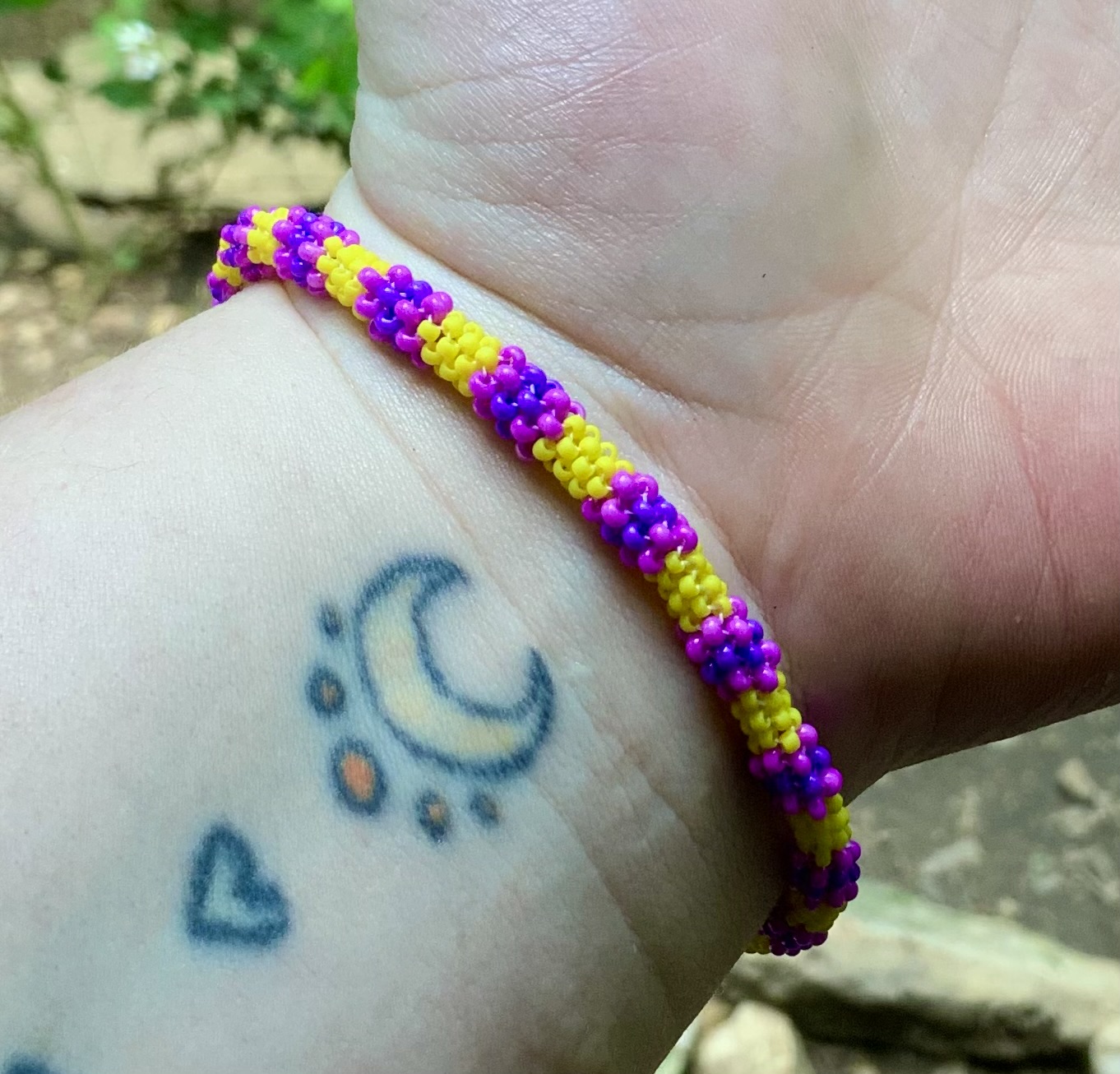 Yellow and purple beaded infinity bracelet