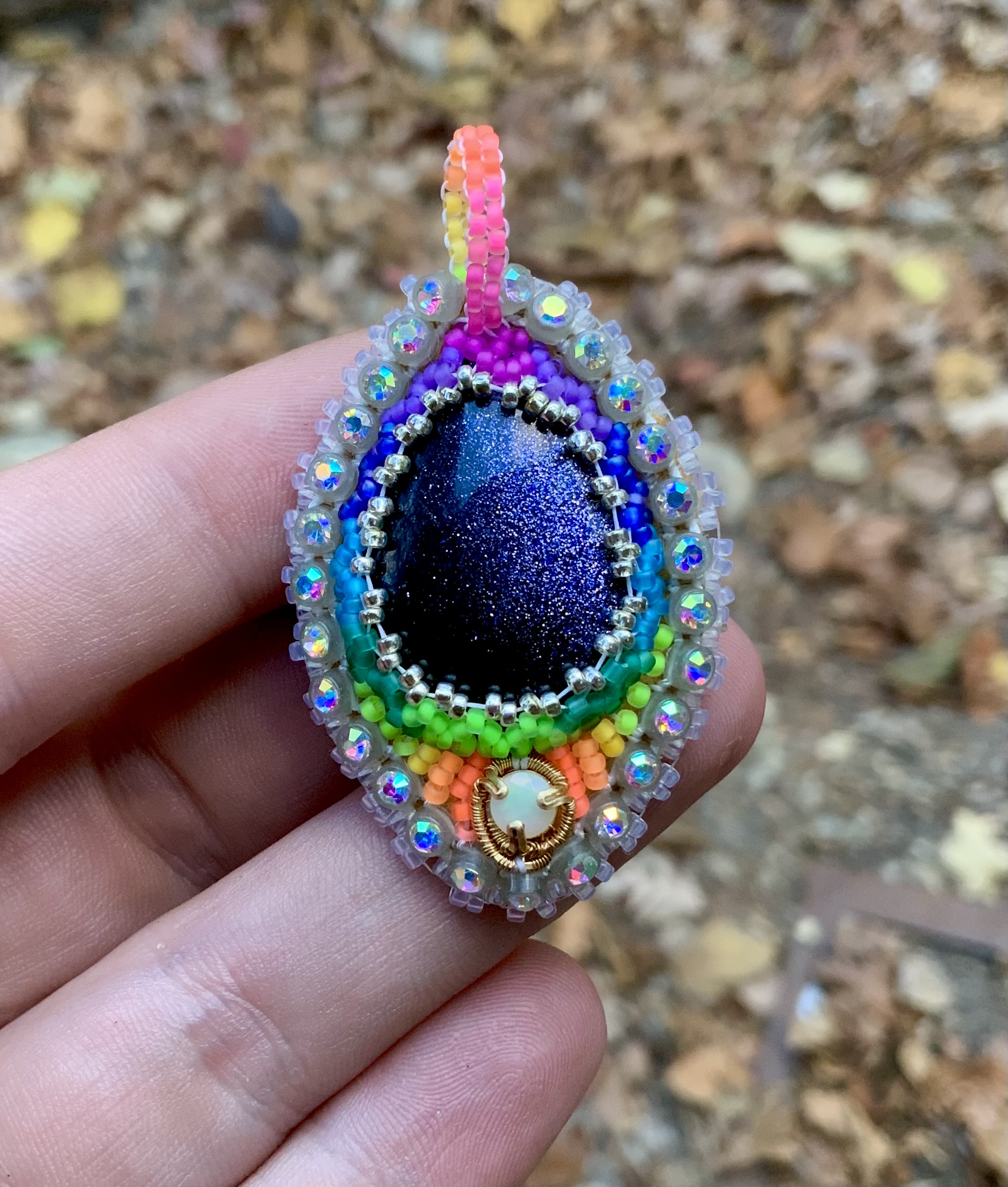 Glow in the dark and blacklight reactive opal and sunstone beaded amulet