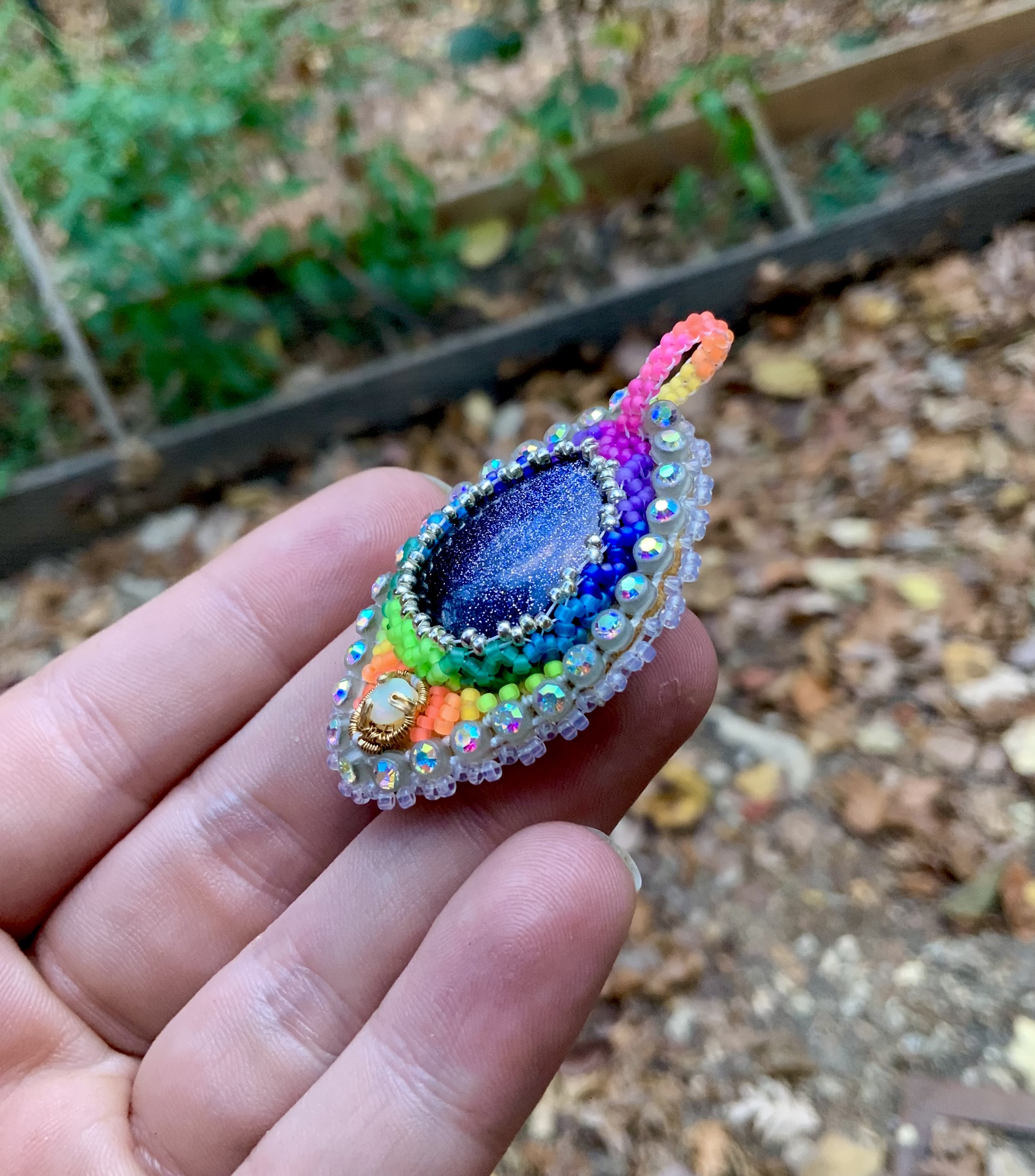 Glow in the dark and blacklight reactive opal and sunstone beaded amulet