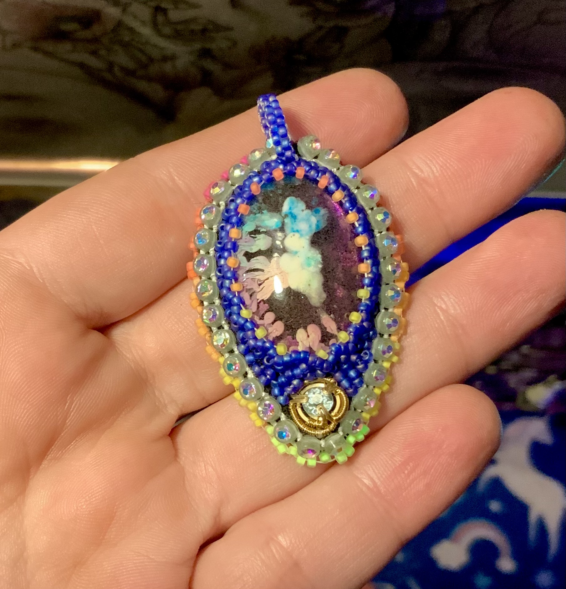 Blacklight reactive glow in the dark blue hue beaded pendant