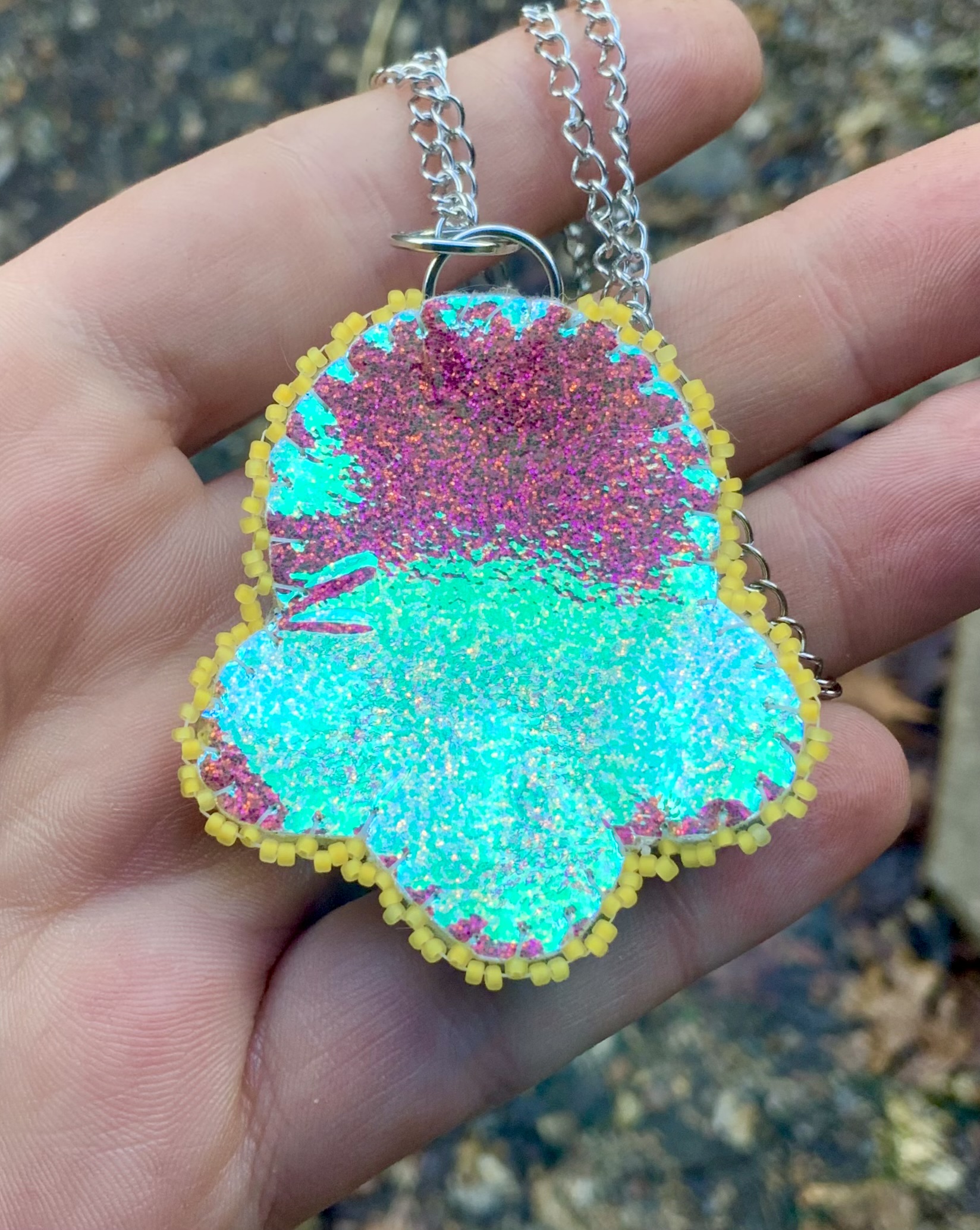 Neon pink Blacklight reactive beaded pendant 