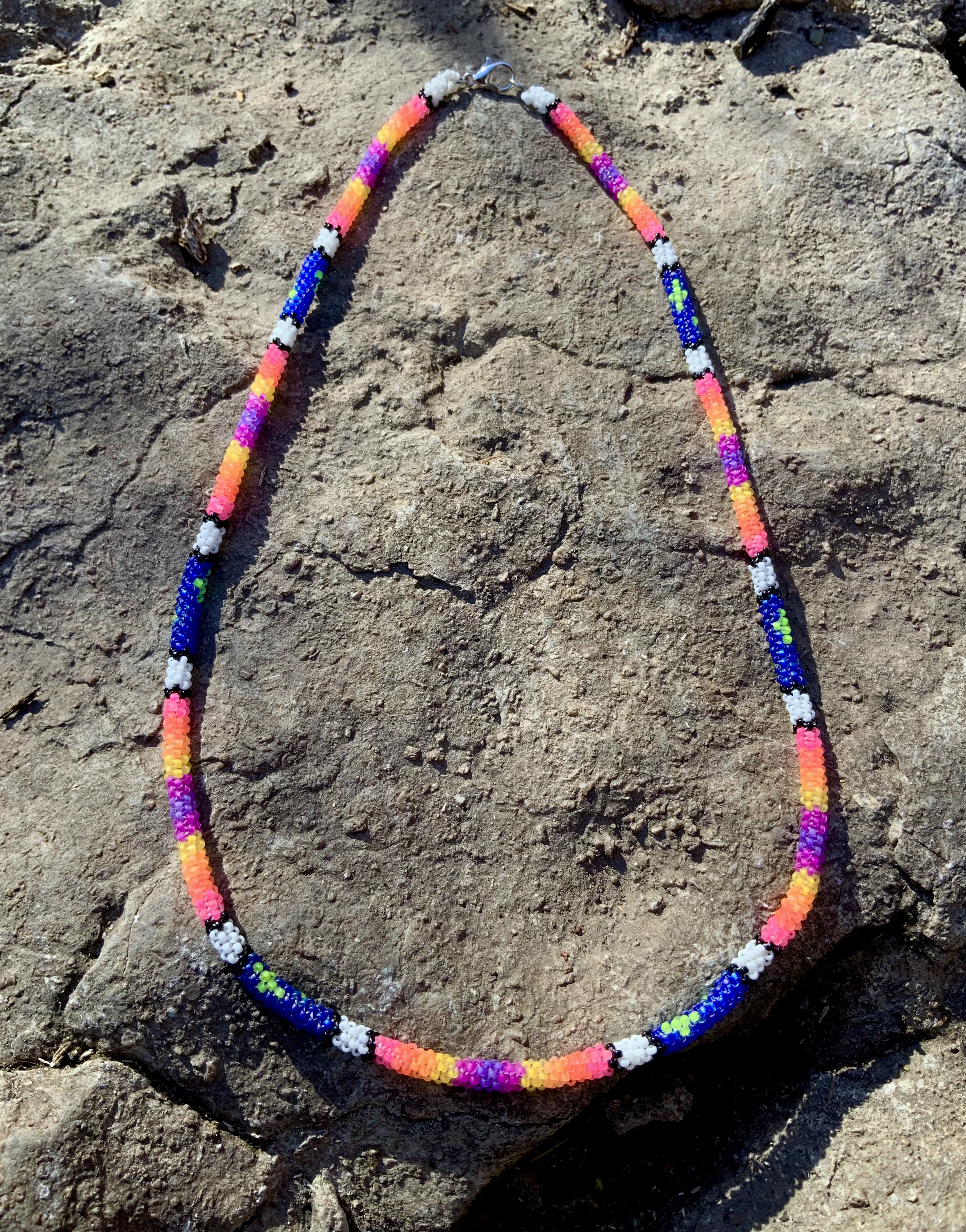 Glowing stars at sunset blacklight reactive gourd stitched necklace 
