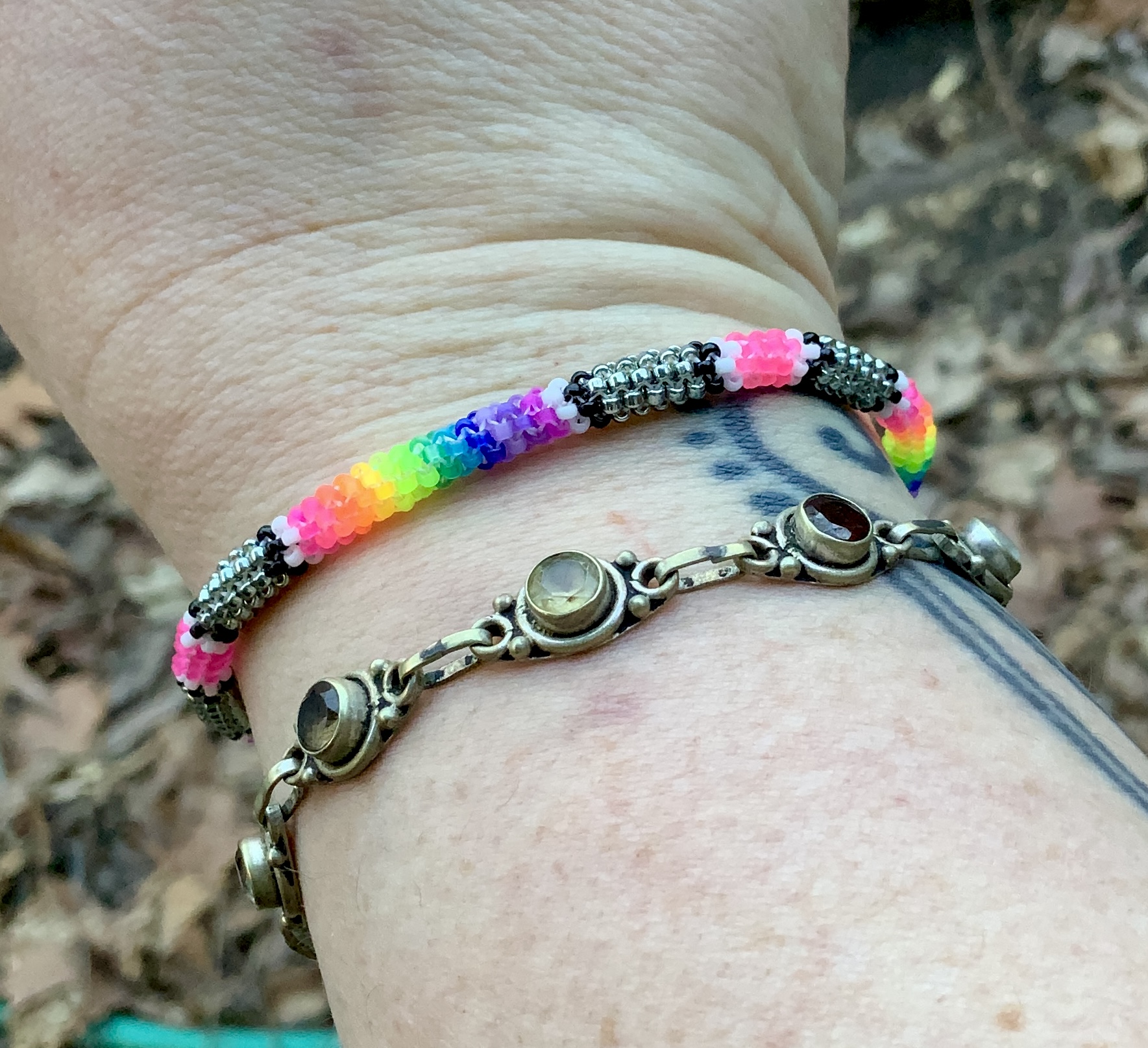 Neon rainbows on steel posts gourd stitched bracelet