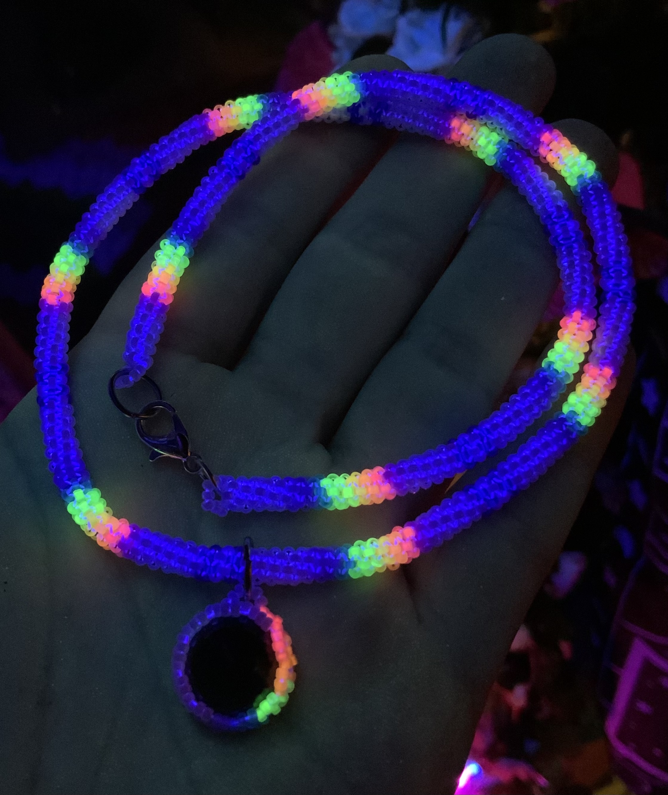 Blacklight reactive rainbows in the clouds gourd stitched necklace 