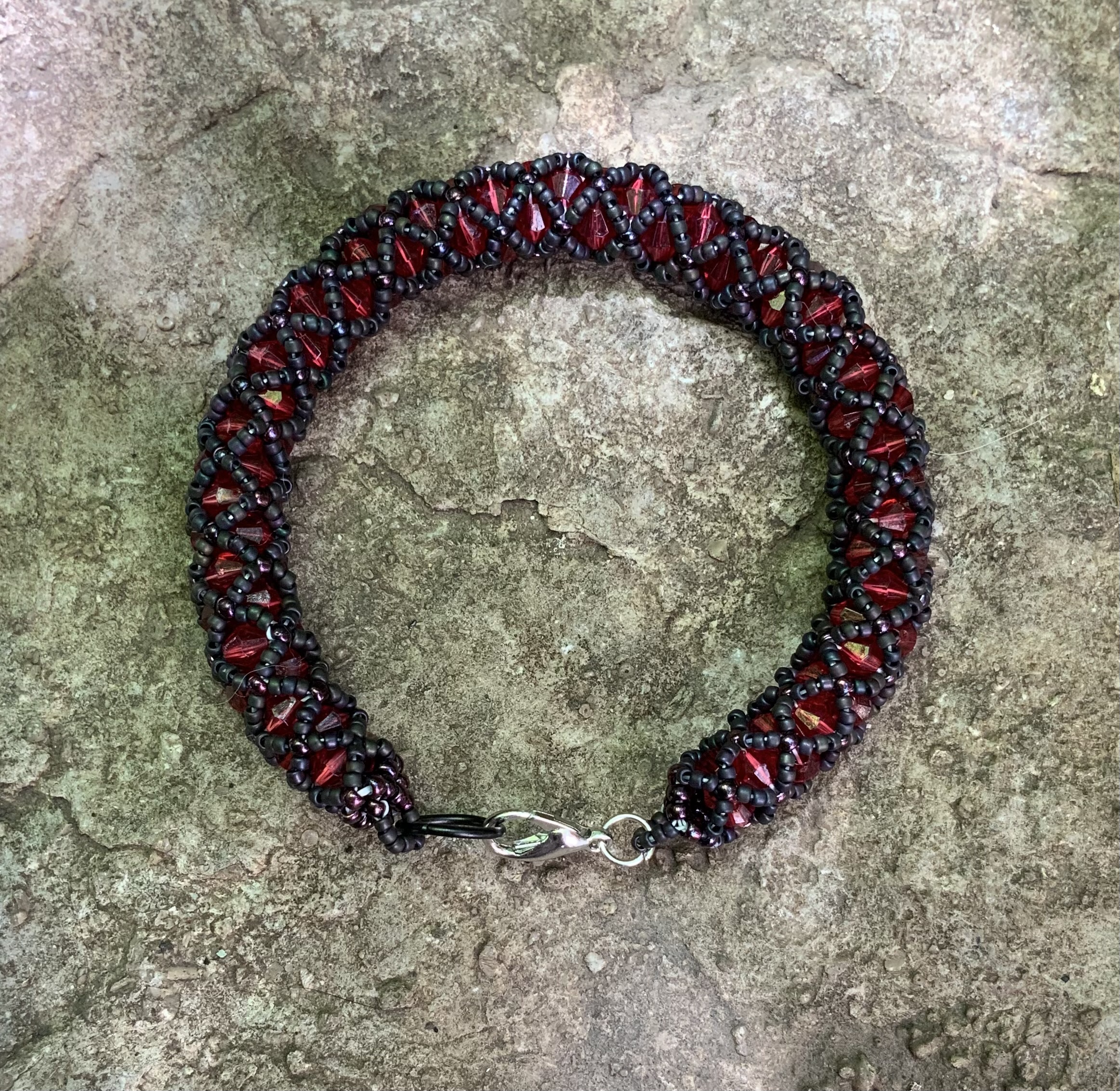 Black and blood red tubular netting beaded bracelet