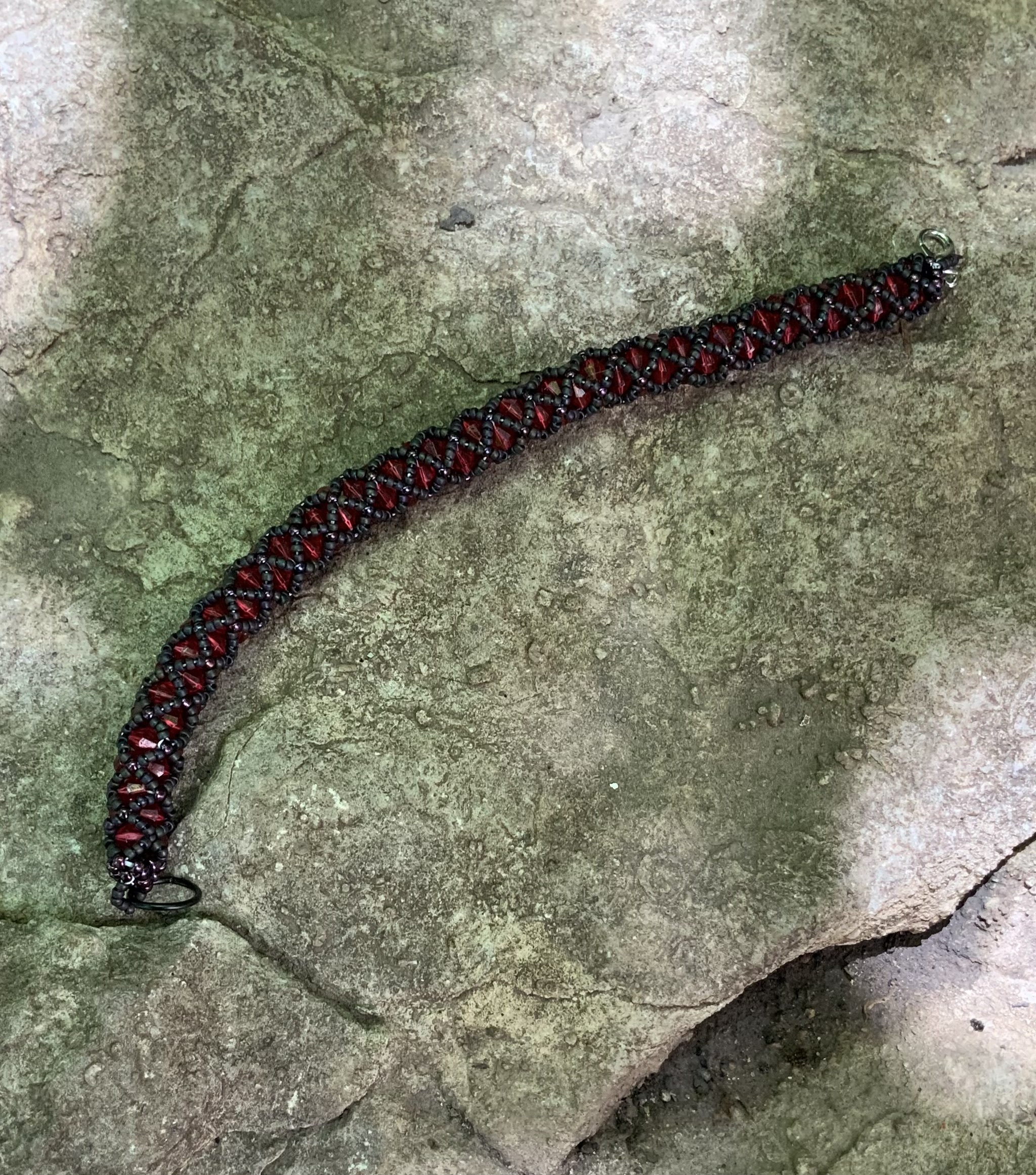 Black and blood red tubular netting beaded bracelet