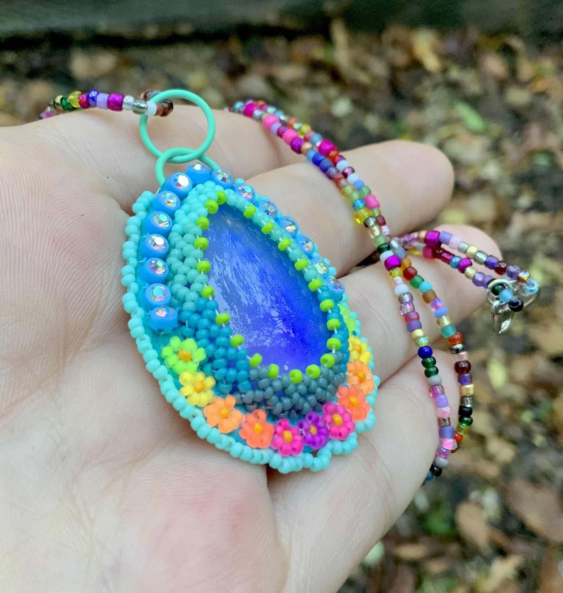 Path of flowers beaded pendant