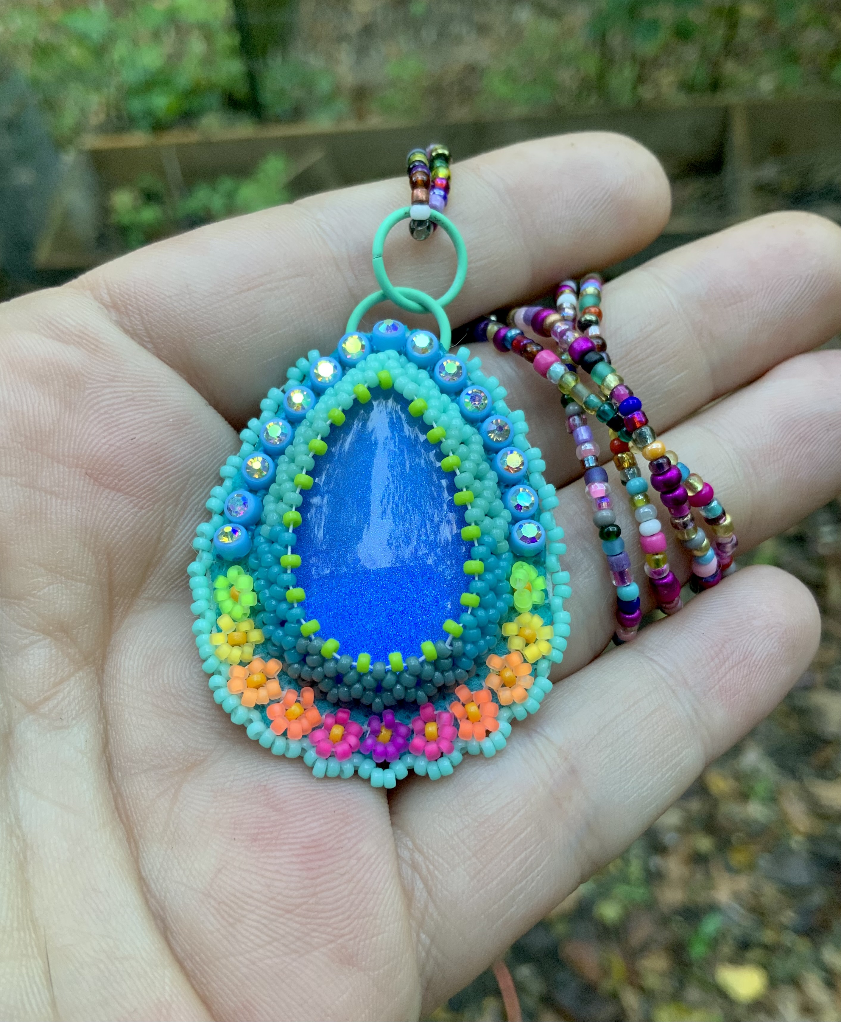 Path of flowers beaded pendant