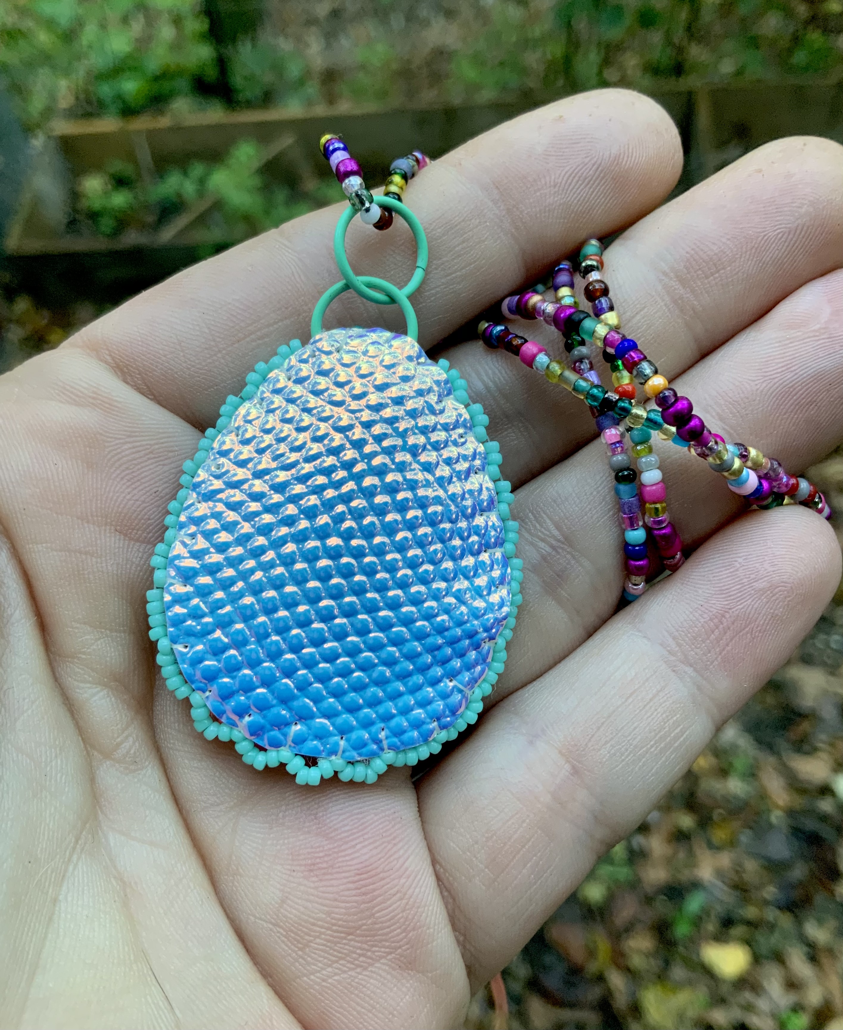 Path of flowers beaded pendant