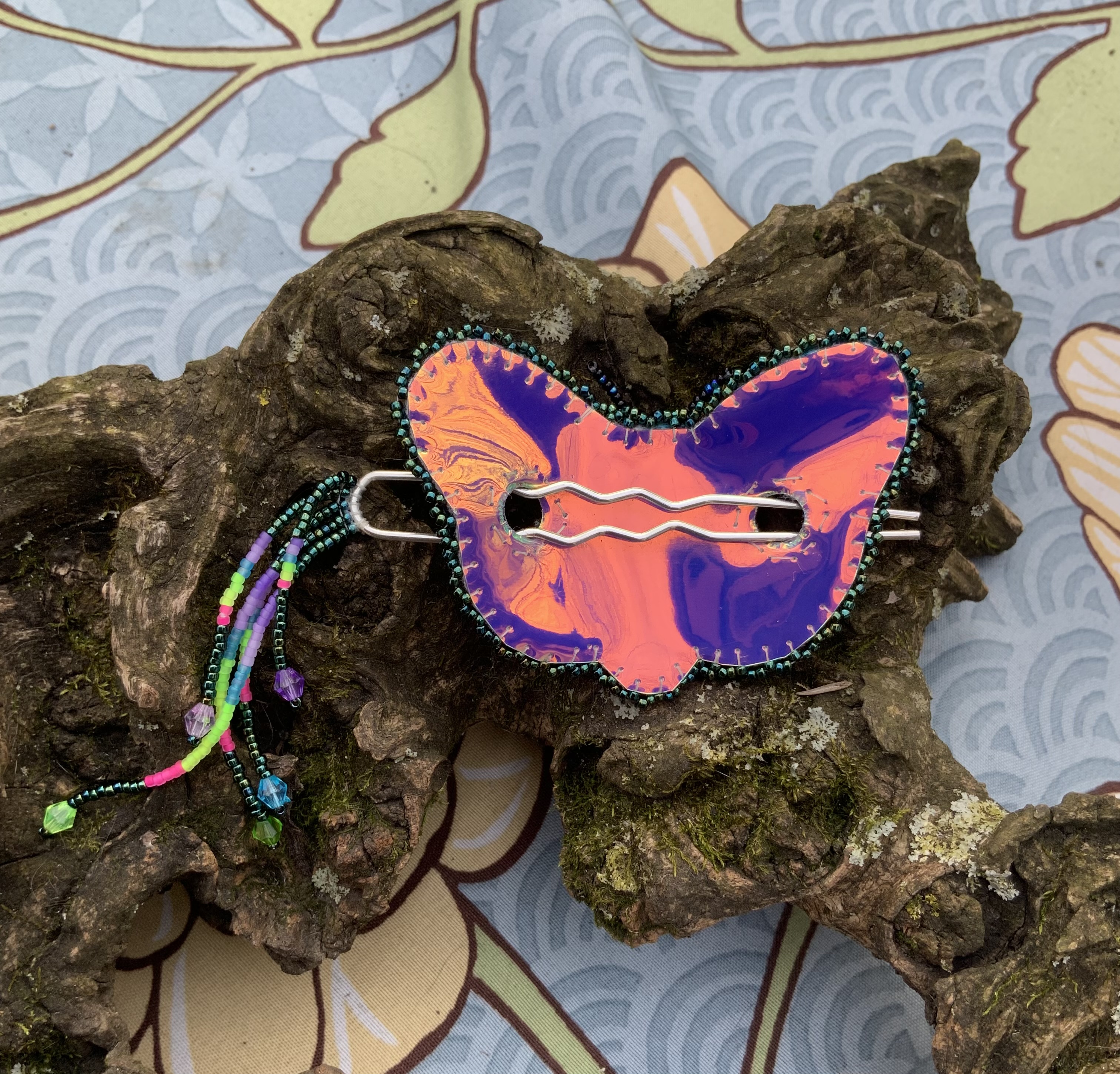 Blacklight reactive beaded moth barrette 
