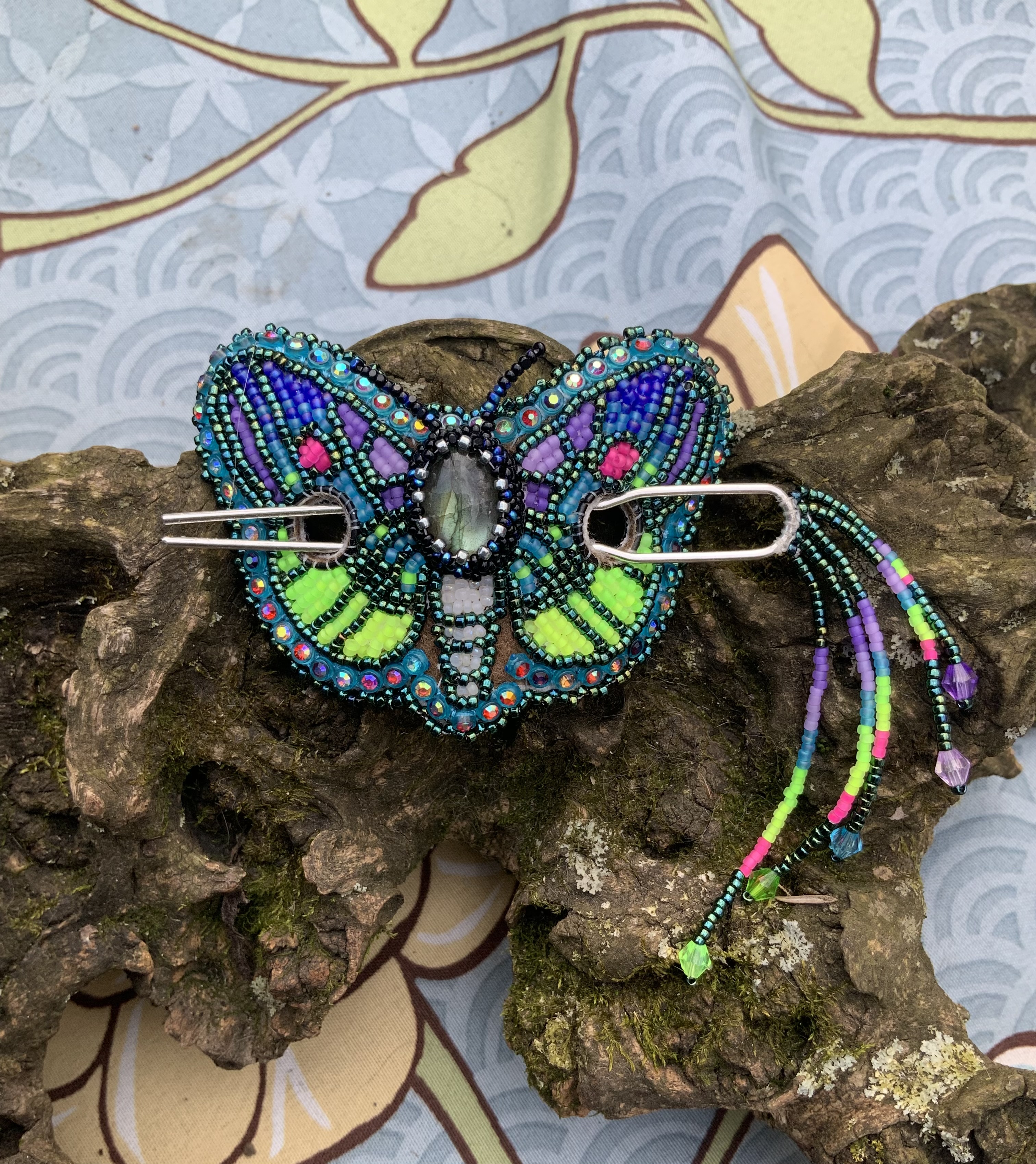 Blacklight reactive beaded moth barrette 