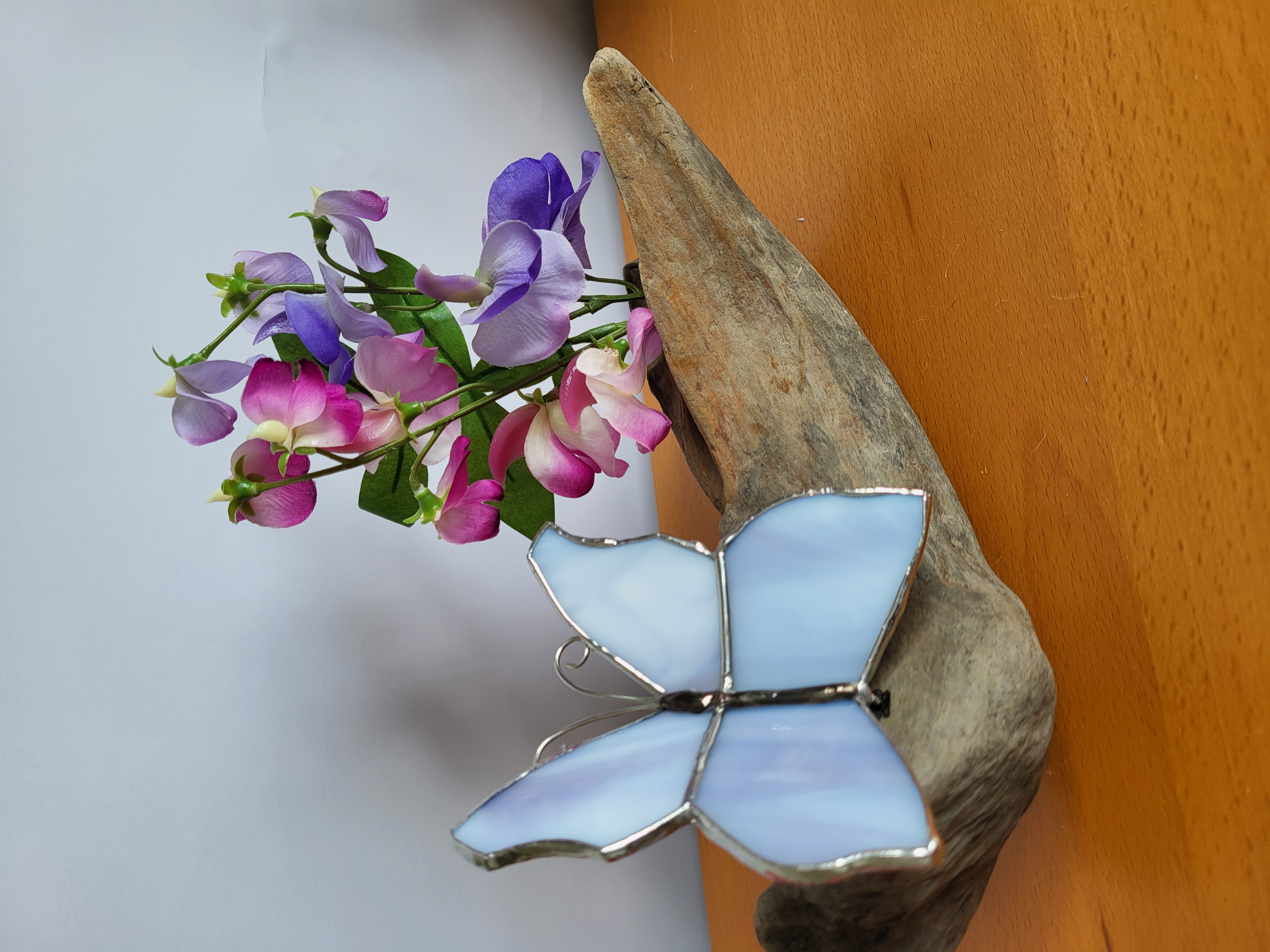 Butterflies and sweet peas on driftwood