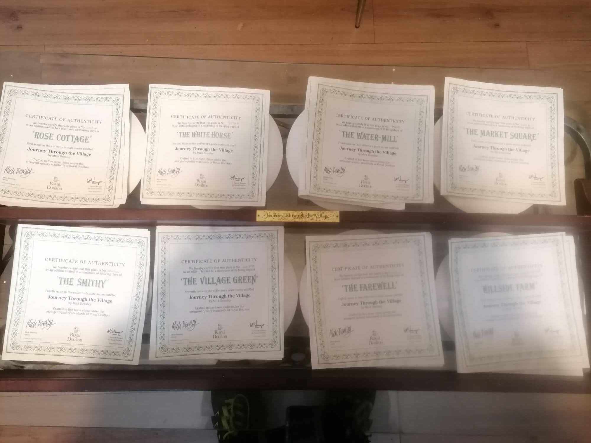 Set of 8 1990s royal doulton plates journey thru the village with genuine plate rack