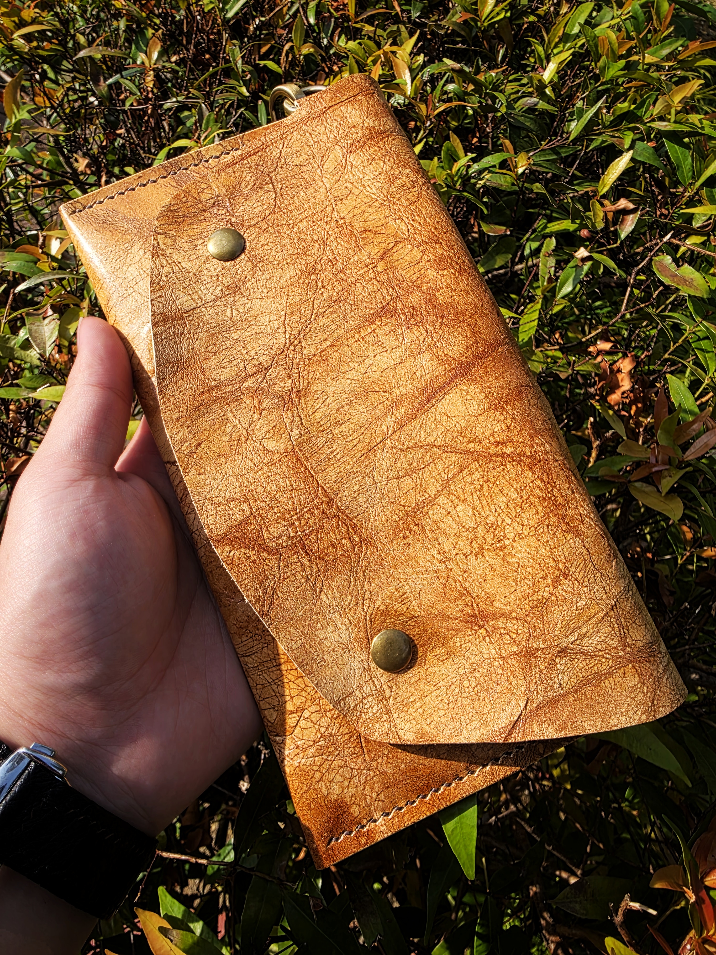 The Nepal: A clutch purse made in exquisite museum brown leather
