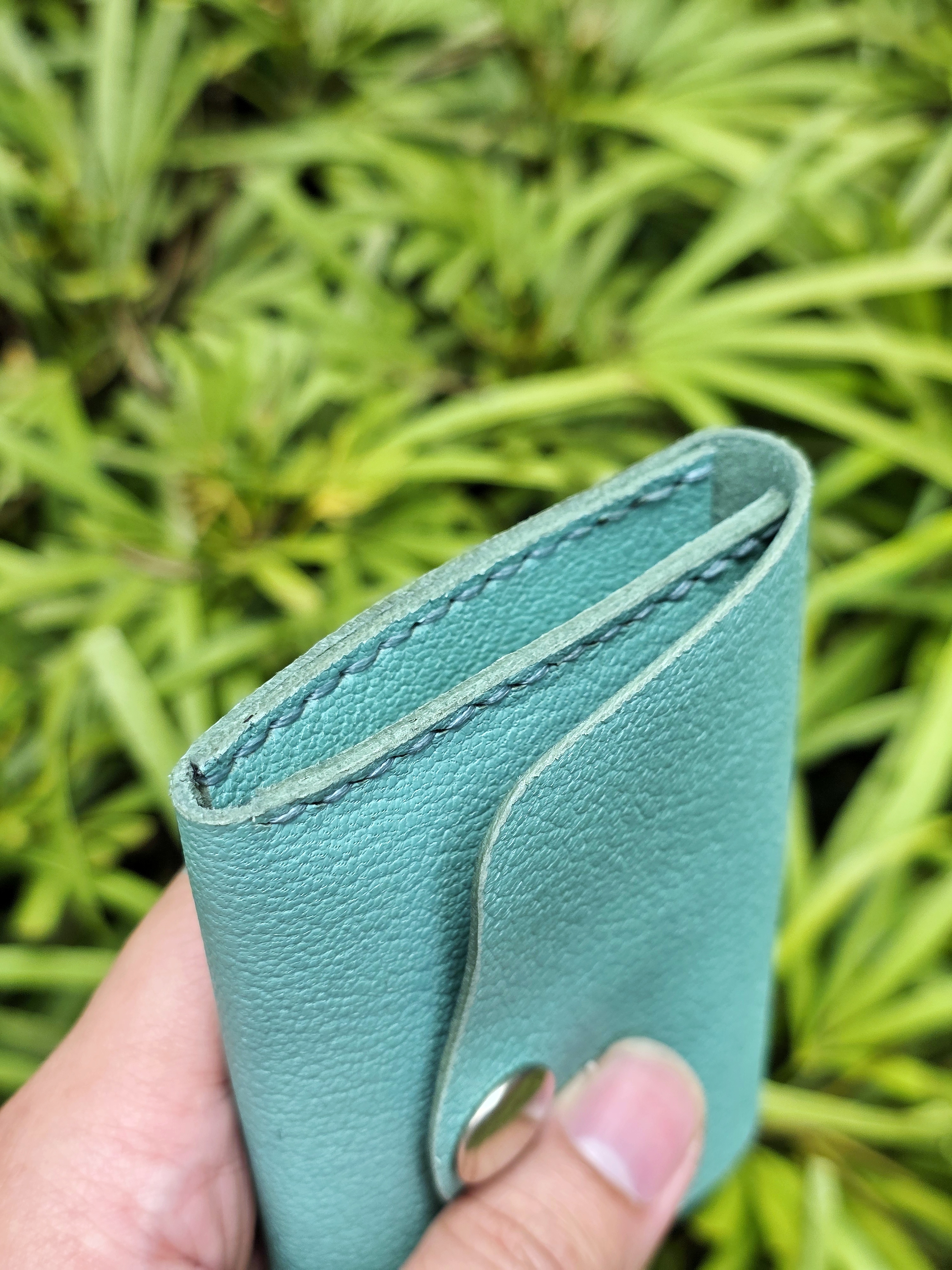 The Venice: a leather 2 pocket card sleeve in tiffany blue