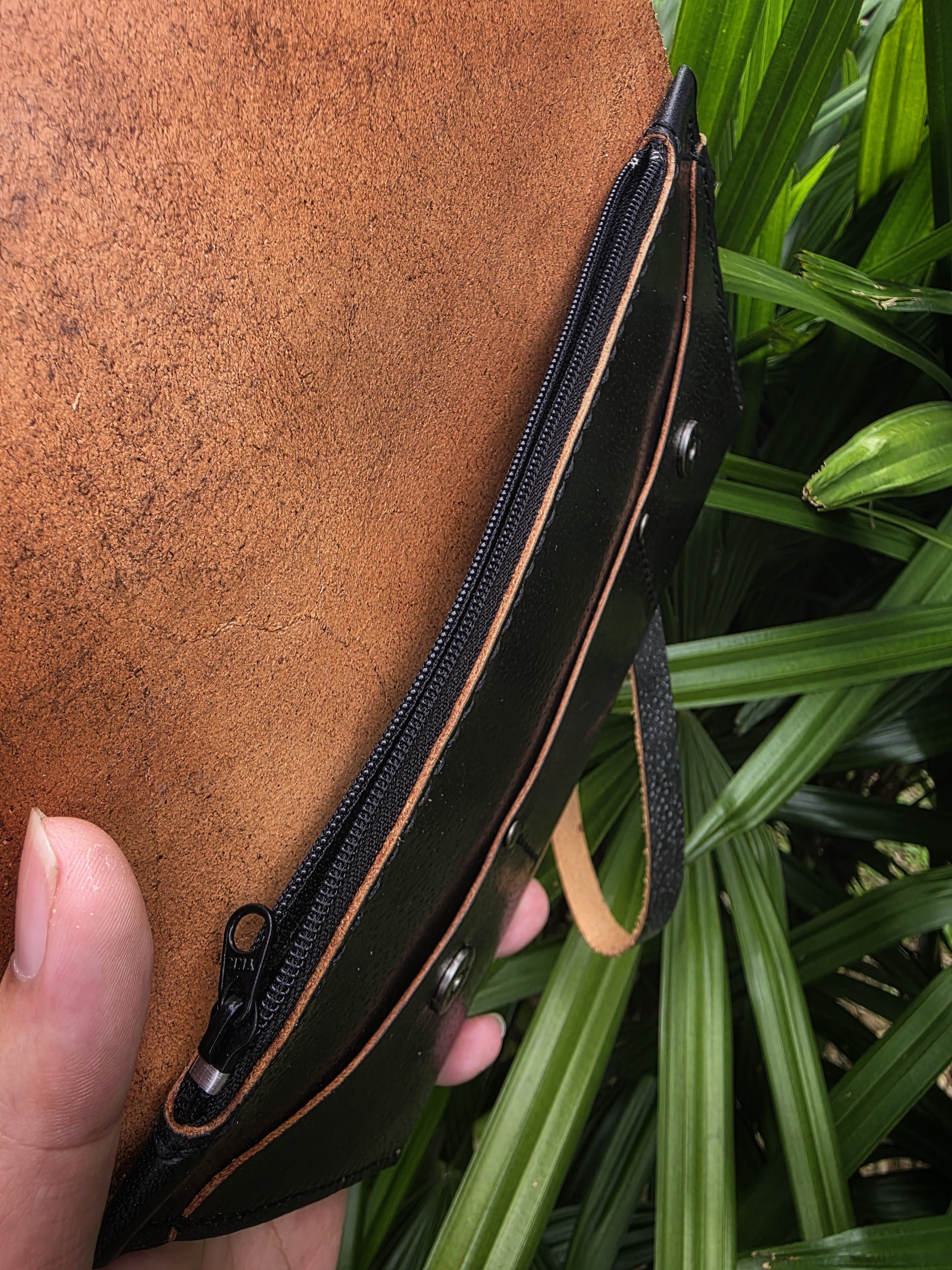 The Nepal: A clutch purse made in black saddle tanned cow leather