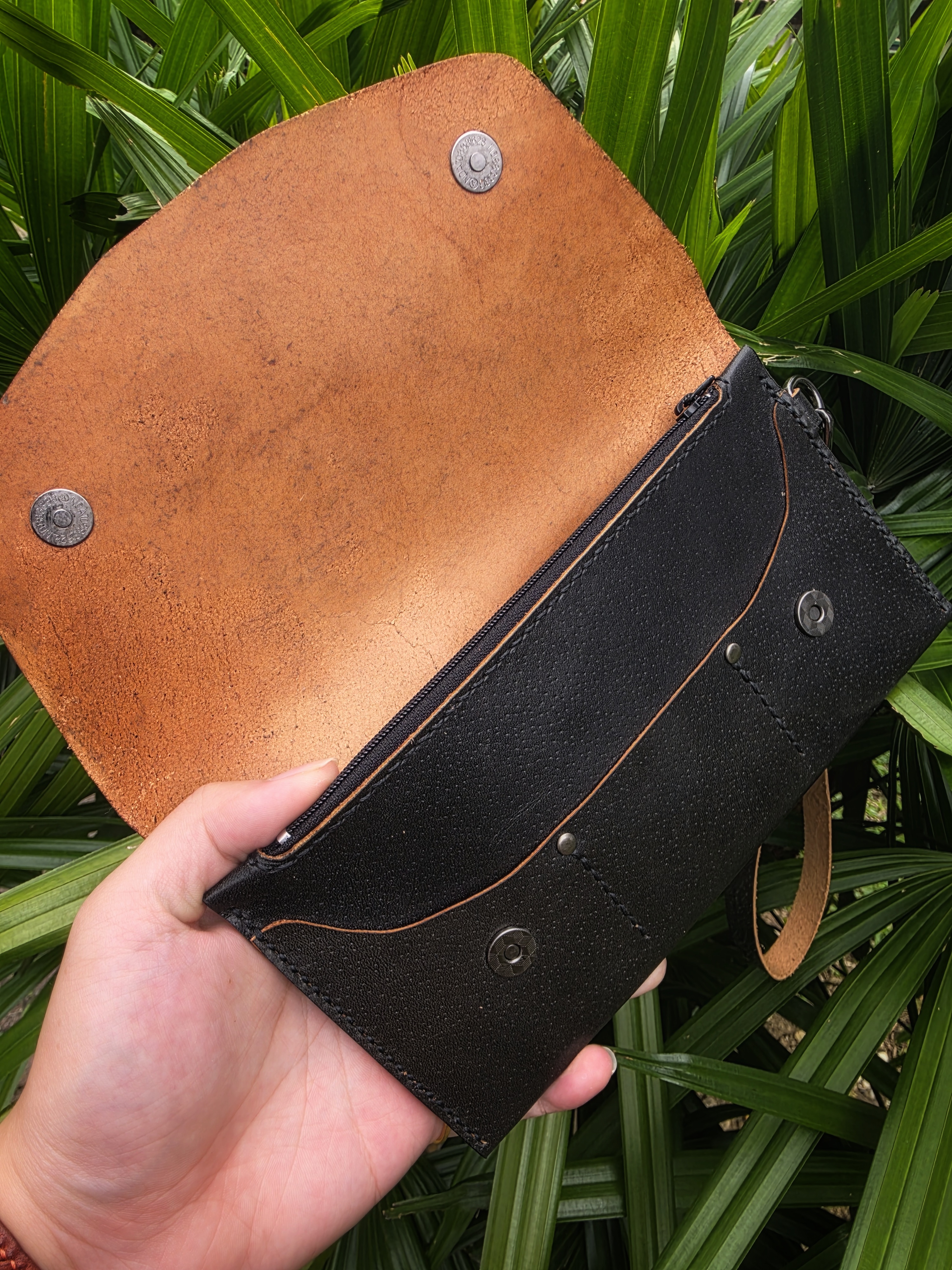 The Nepal: A clutch purse made in black saddle tanned cow leather