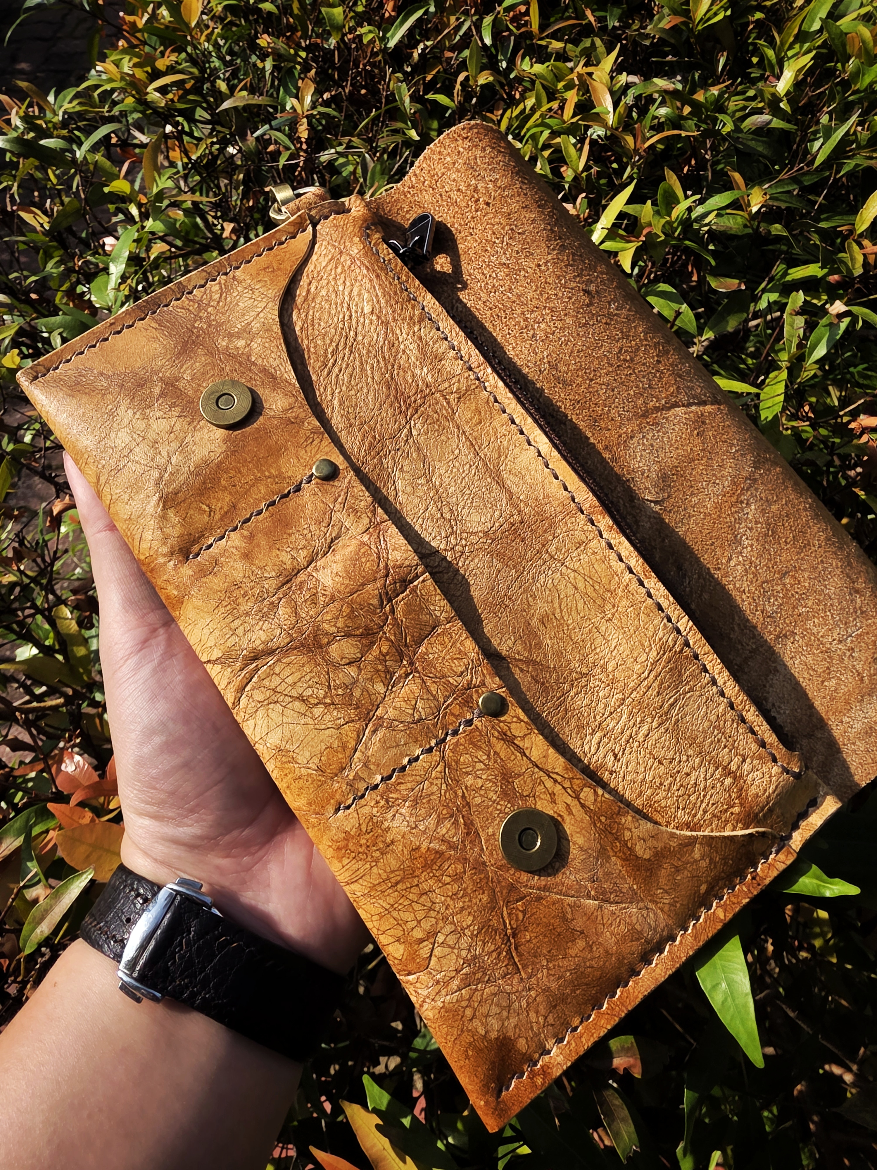 The Nepal: A clutch purse made in exquisite museum brown leather