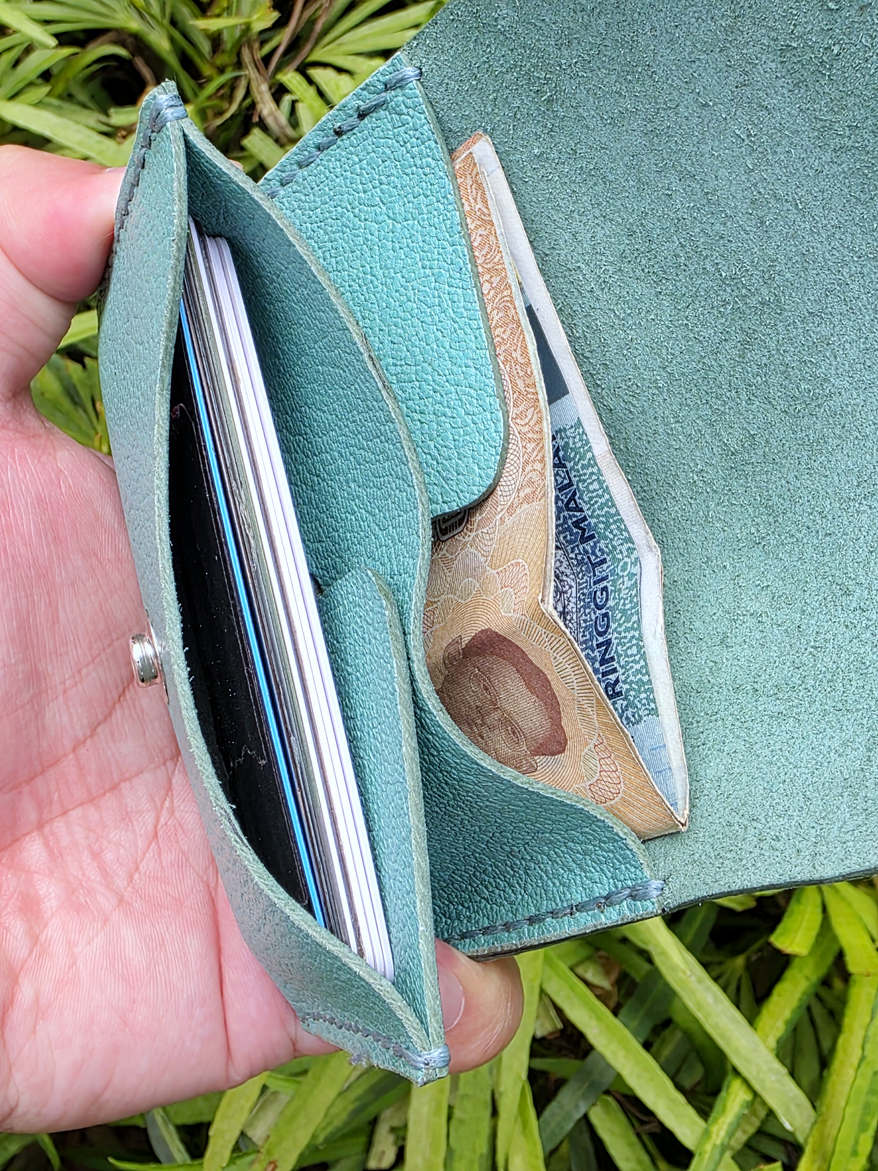 The Venice: a leather 2 pocket card sleeve in tiffany blue