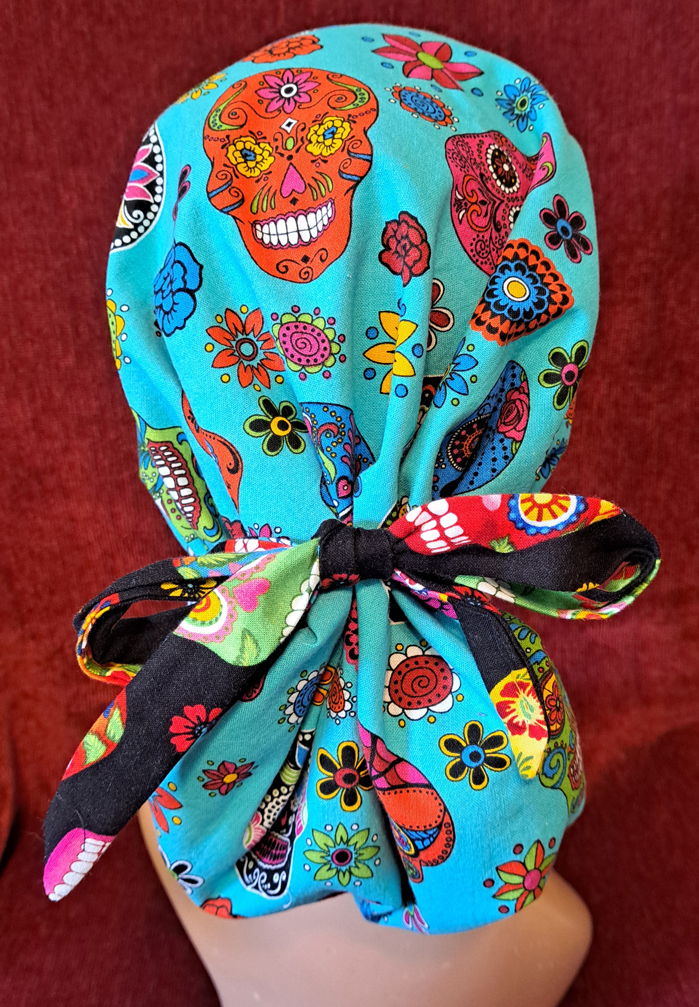 Handmade Reversible Pony Tail Scrub Cap - Turquoise Skull Fabric Reverses to Black Skull Fabric