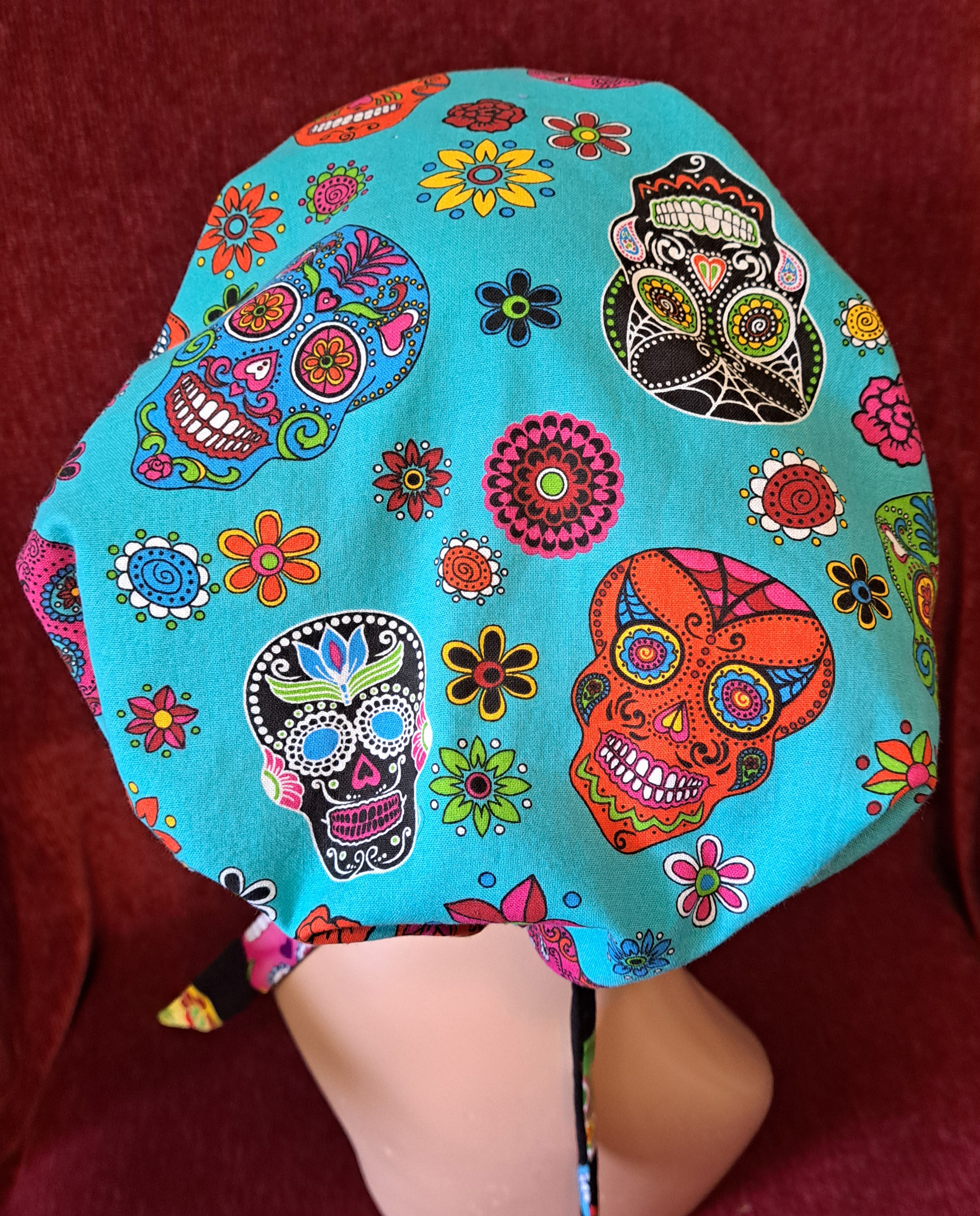Handmade Reversible Pony Tail Scrub Cap - Turquoise Skull Fabric Reverses to Black Skull Fabric