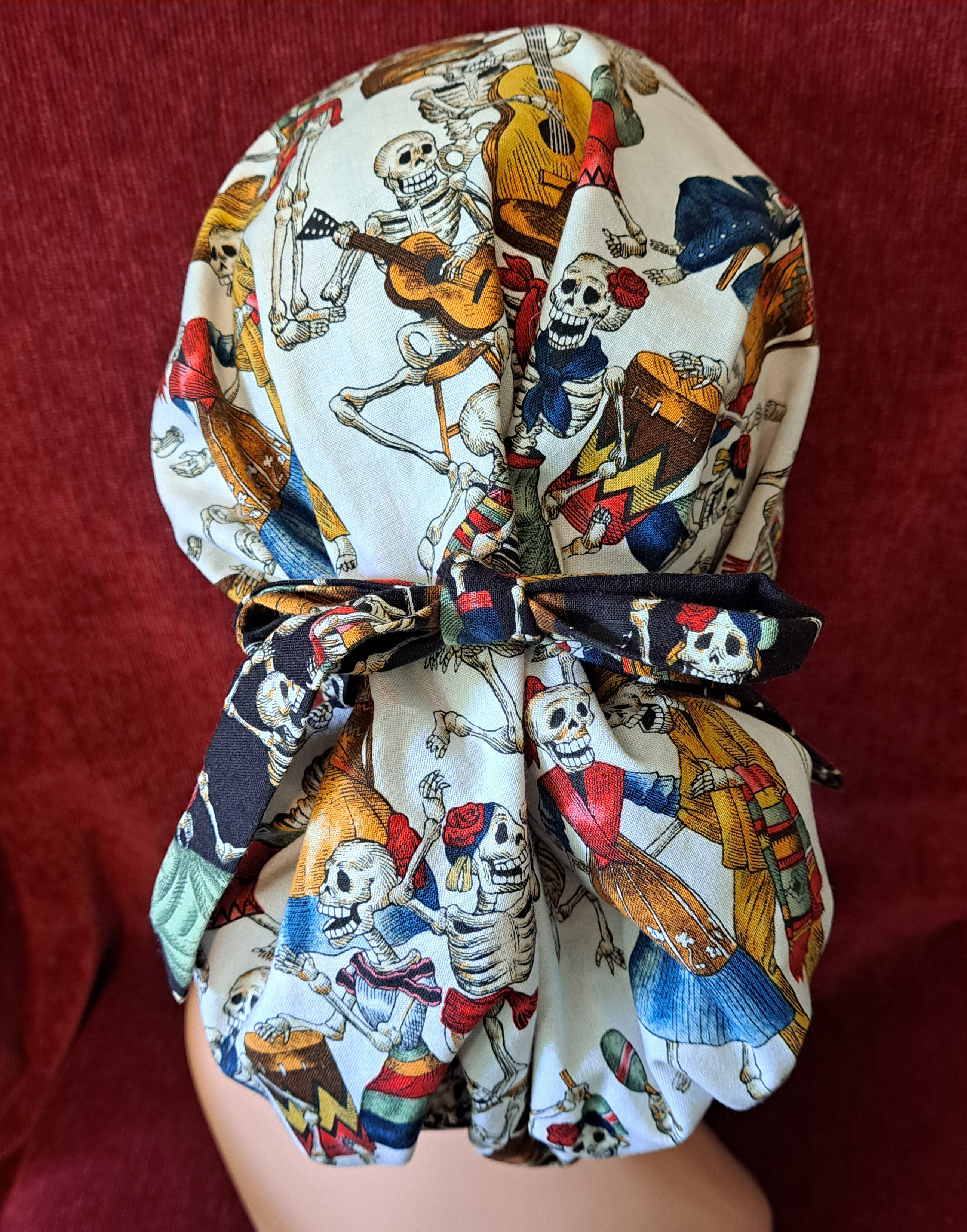 Handmade Reversible Pony Tail Scrub Cap - White Skeleton Fabric Reverses to Black Skeleton Fabric