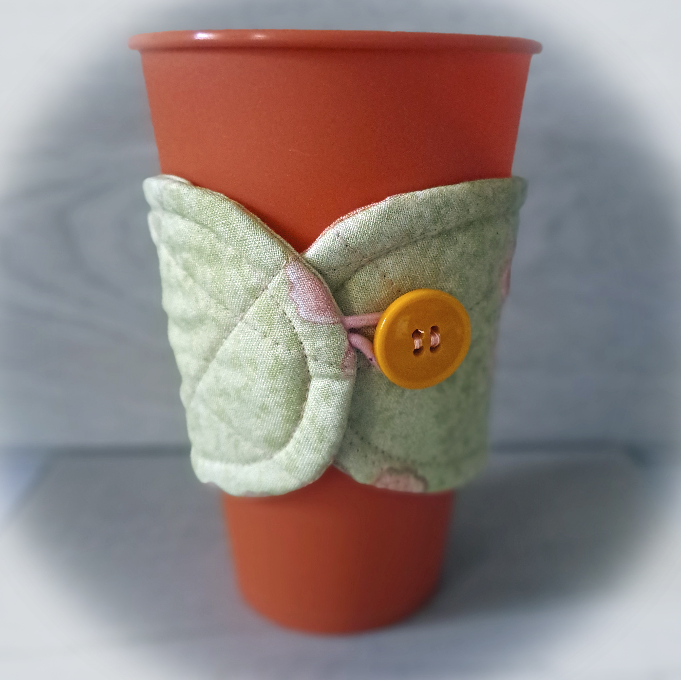 Handmade Reusable Cup Sleeve/Mug Cozy in a Soft Green with Peach Flower Fabric