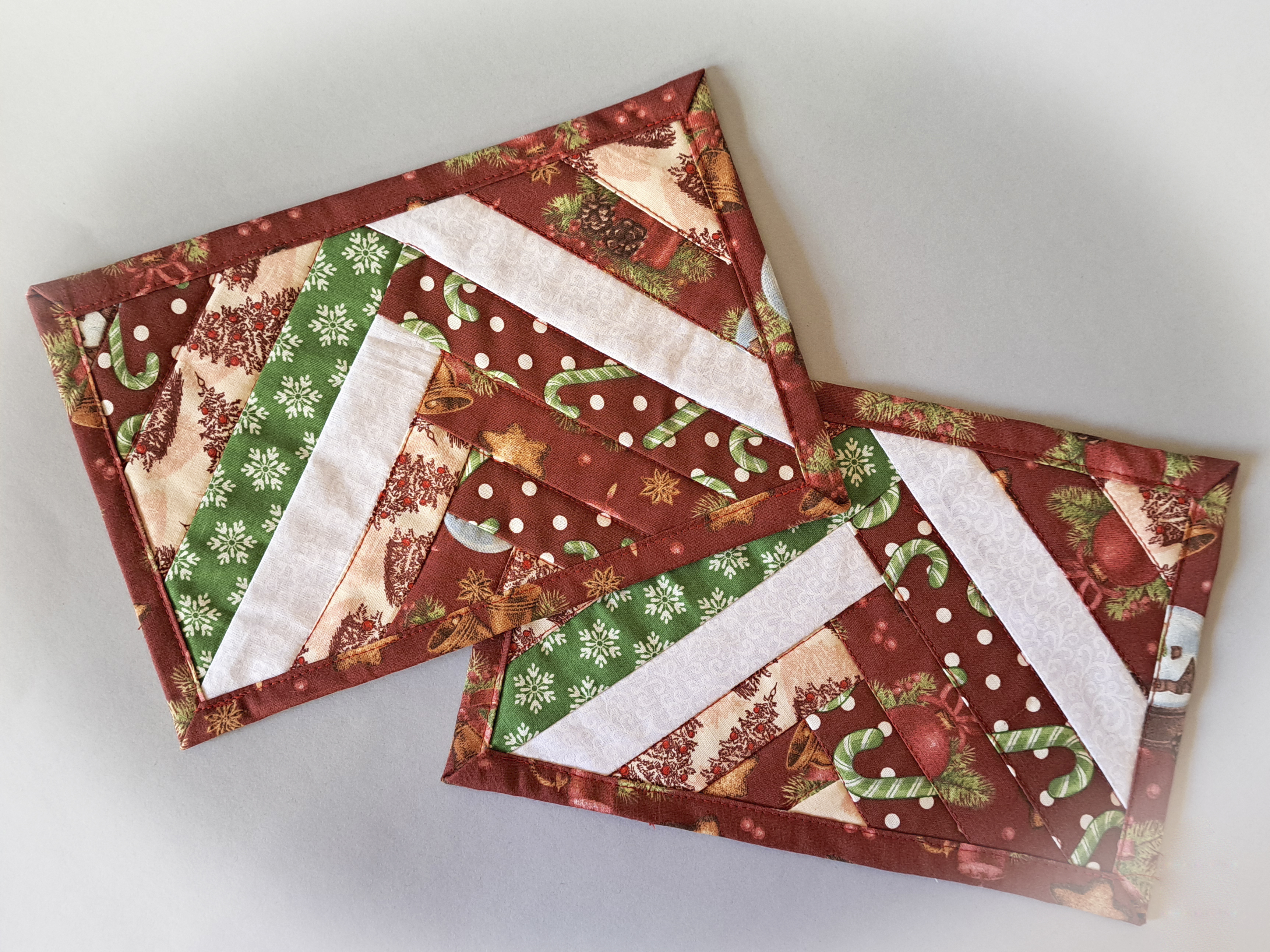 Handmade Fabric Quilted Holiday Mug Rugs - Red and White with Green Snowflake Pattern Fabric - Braid Design - Set of 2