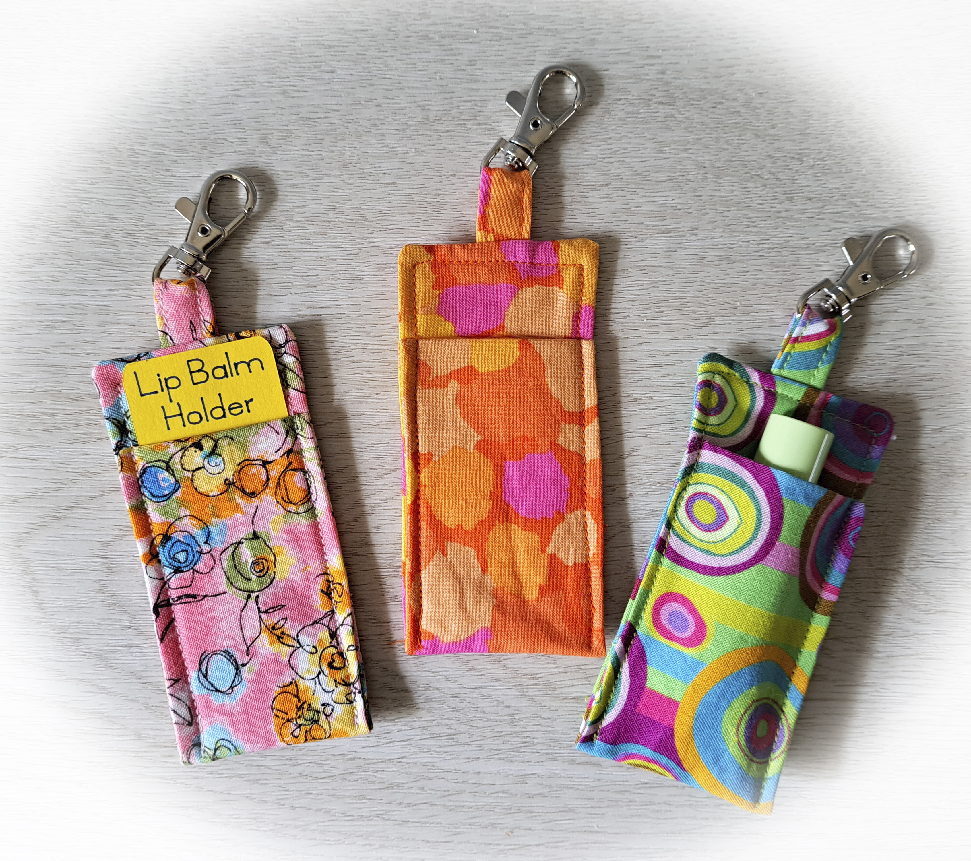 Handmade Fabric Lip Balm Holder with Rotating Clasp - Pink Flowers, Orange Flowers or Green Geometric - Single or Set of 3