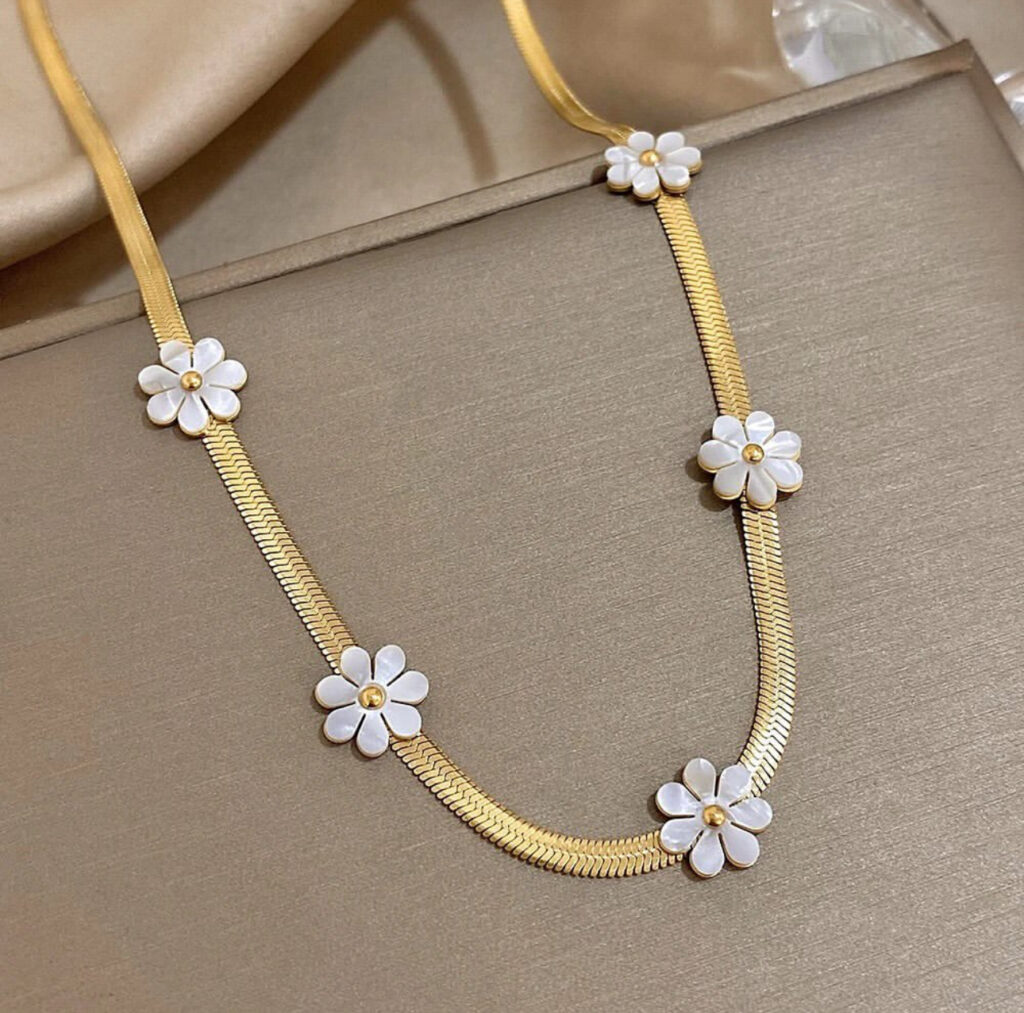 Gold Necklace with White Floral Accents