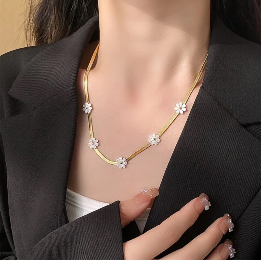 Gold Necklace with White Floral Accents