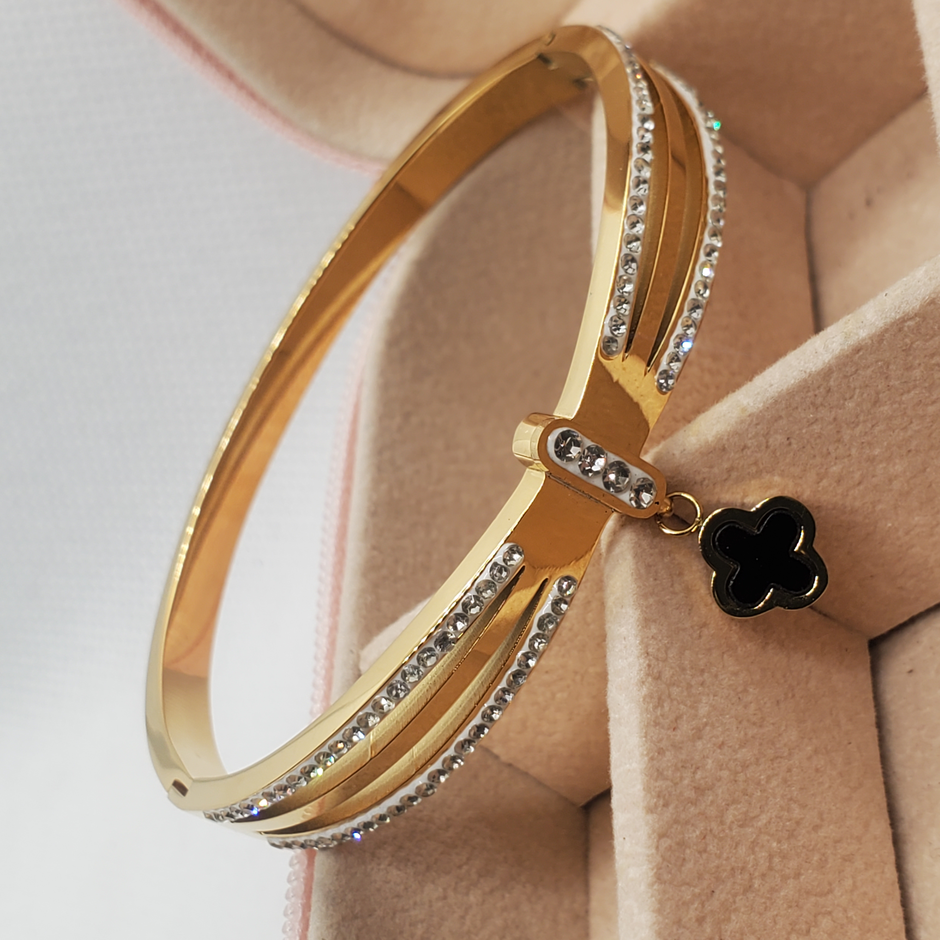 Elegant Gold-Toned Bangle Bracelet with Clover Charm