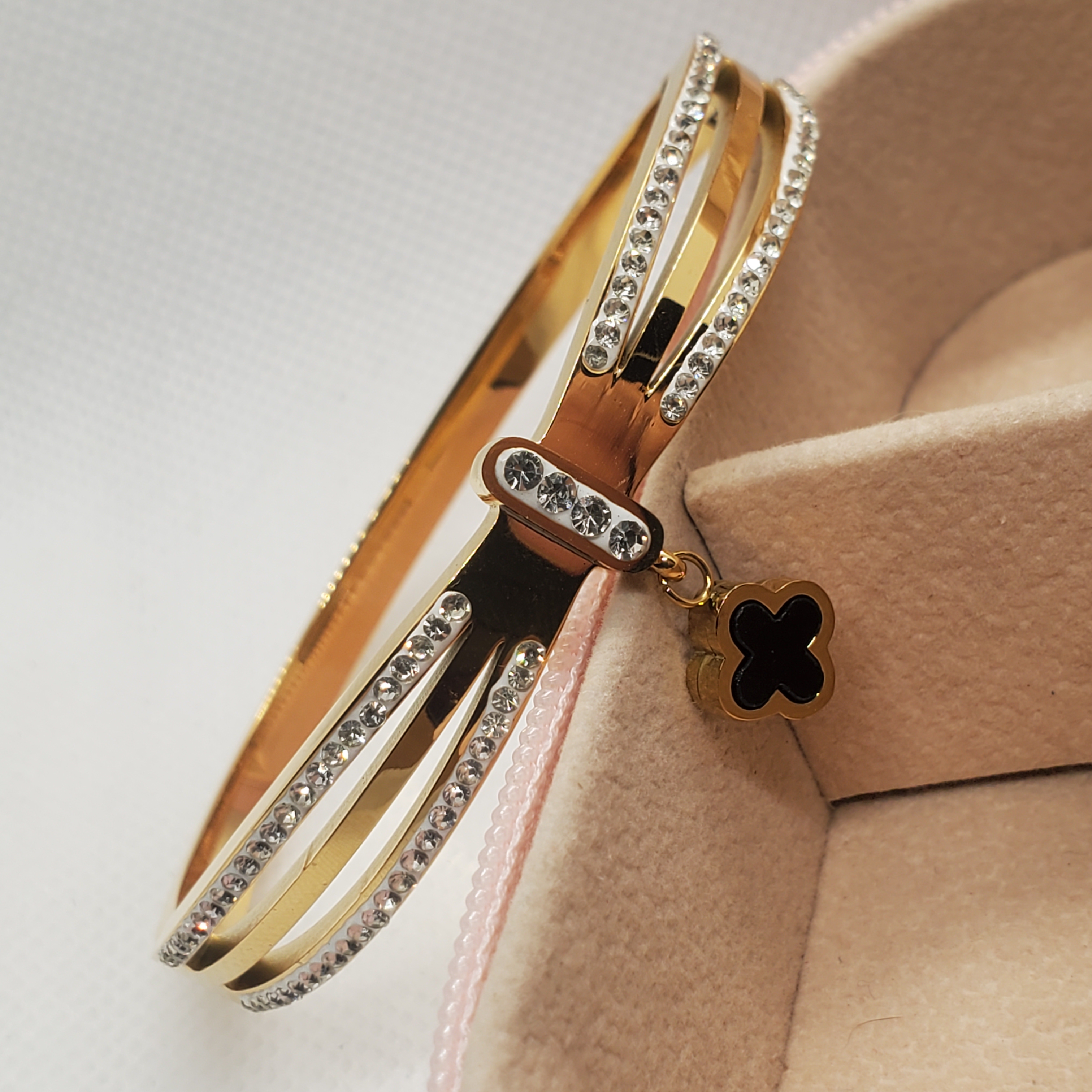 Elegant Gold-Toned Bangle Bracelet with Clover Charm