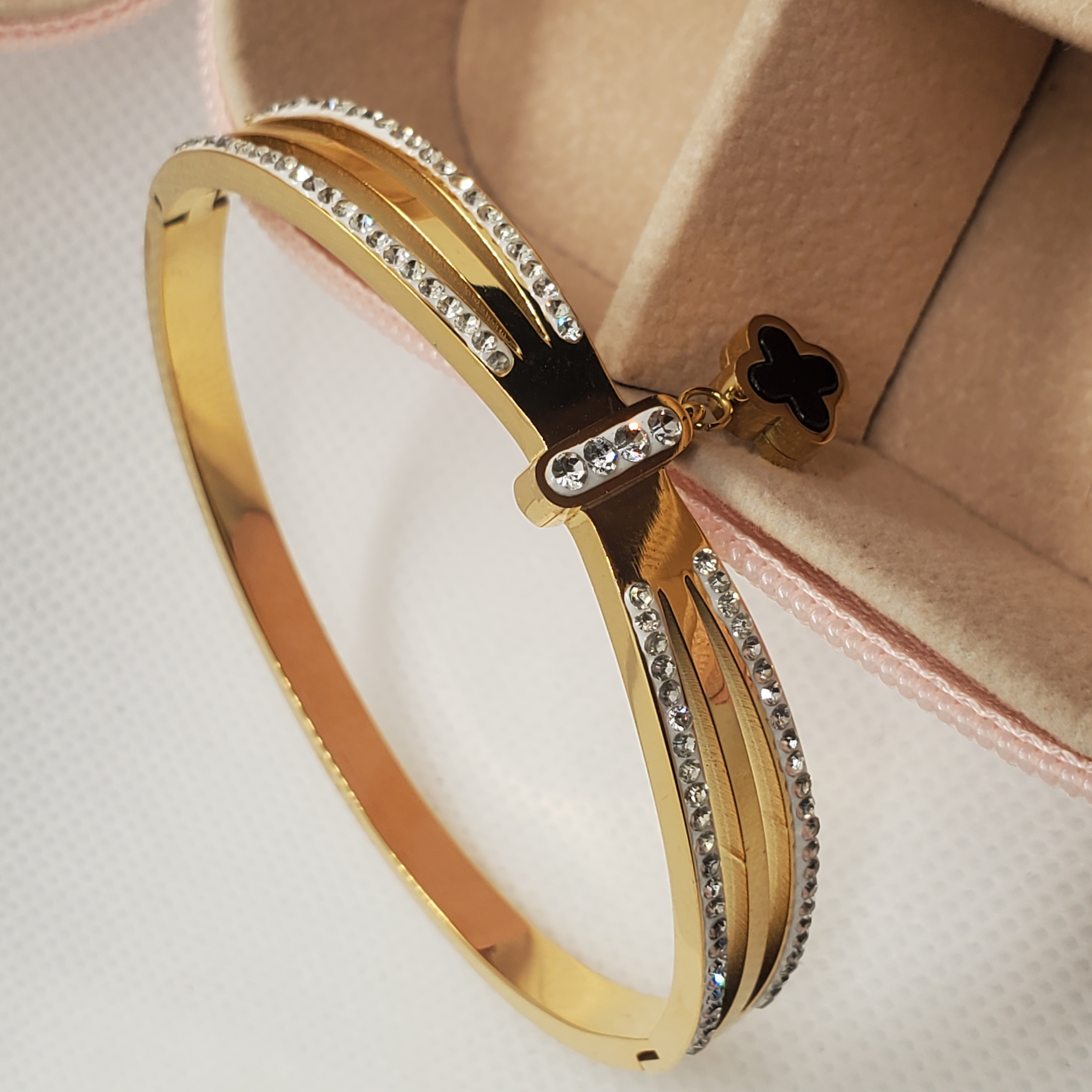 Elegant Gold-Toned Bangle Bracelet with Clover Charm