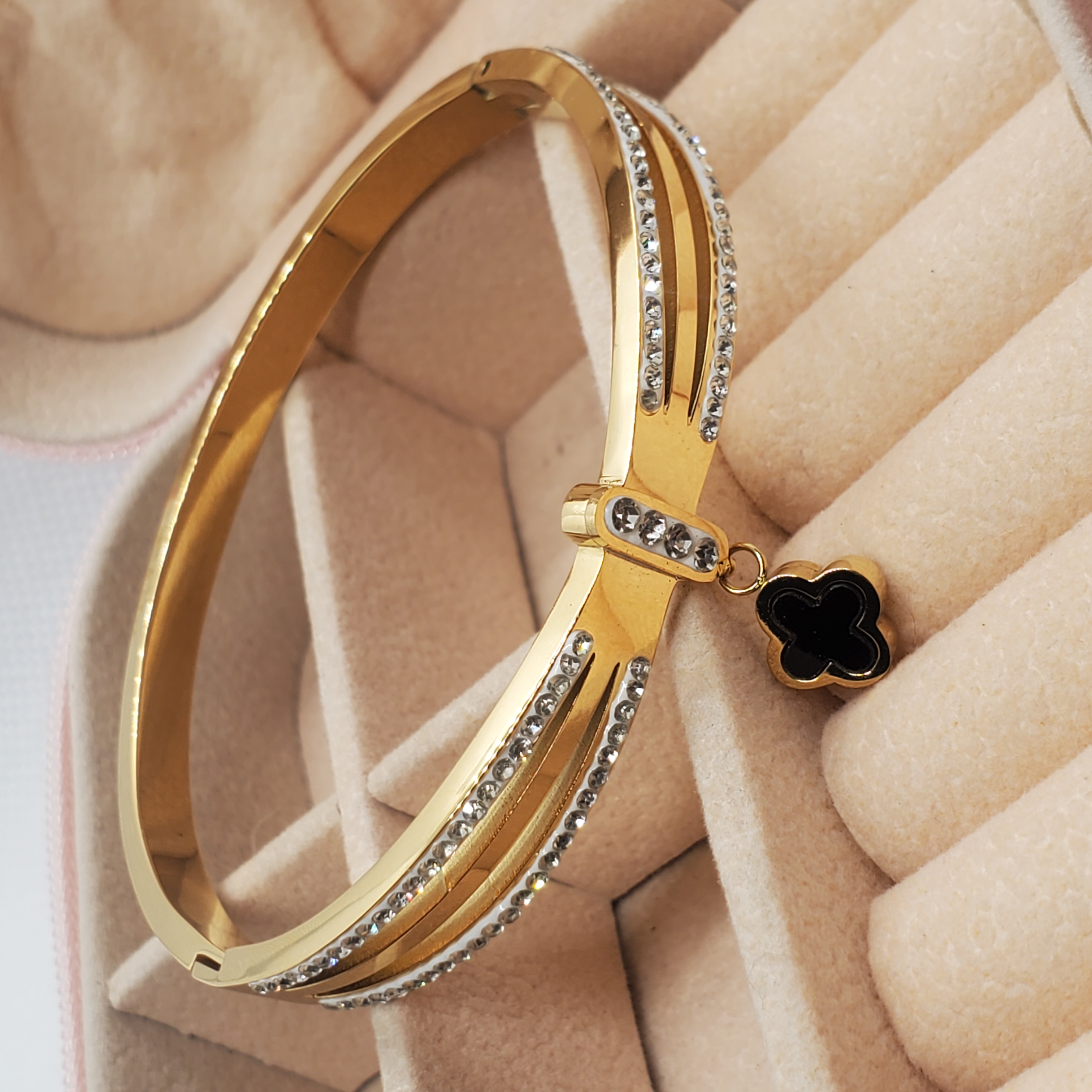 Elegant Gold-Toned Bangle Bracelet with Clover Charm