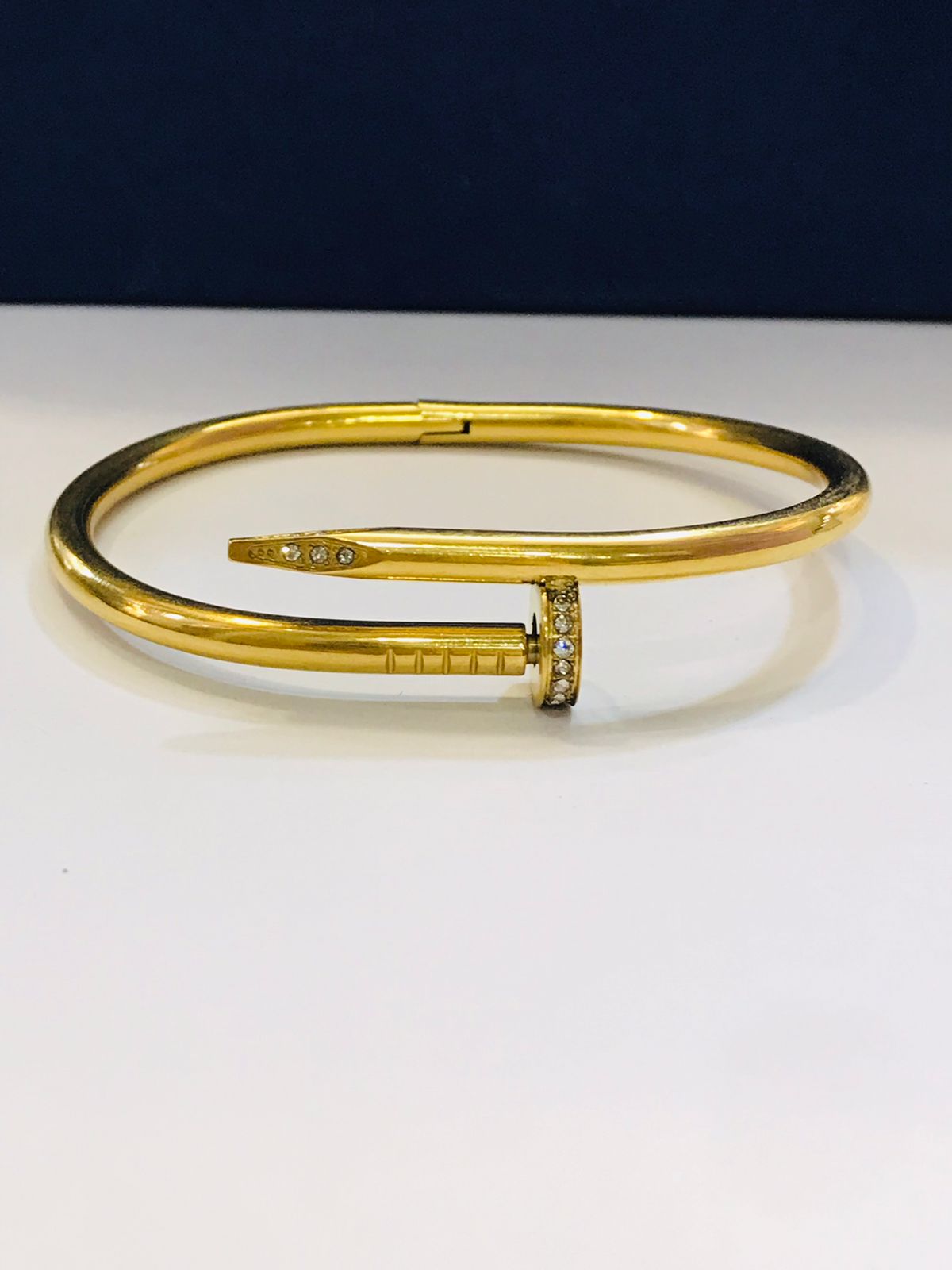 Elegant Gold-Tone Nail Bangle with Stone Embellishment
