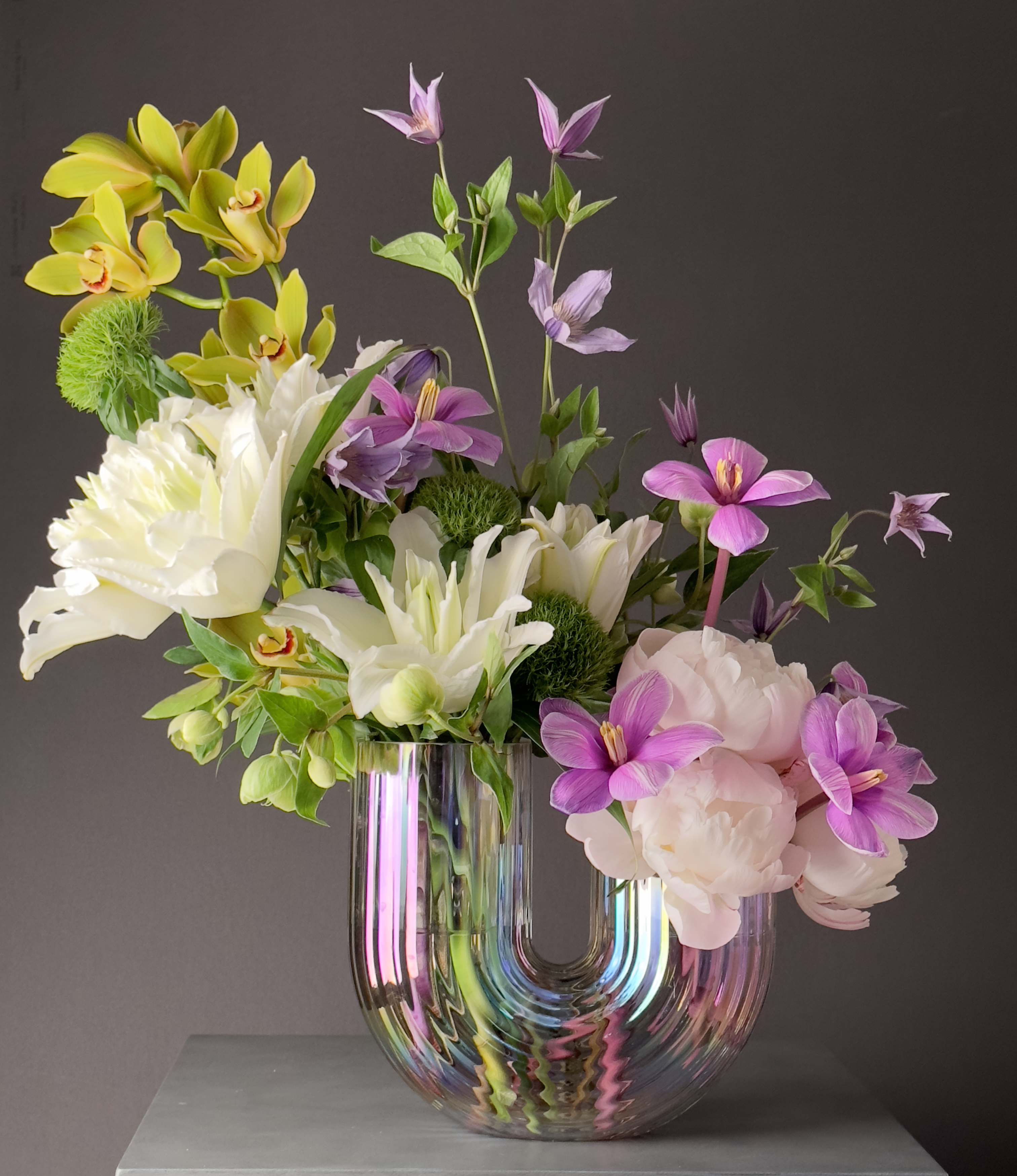 Iridescent glass vase with floral arrangement