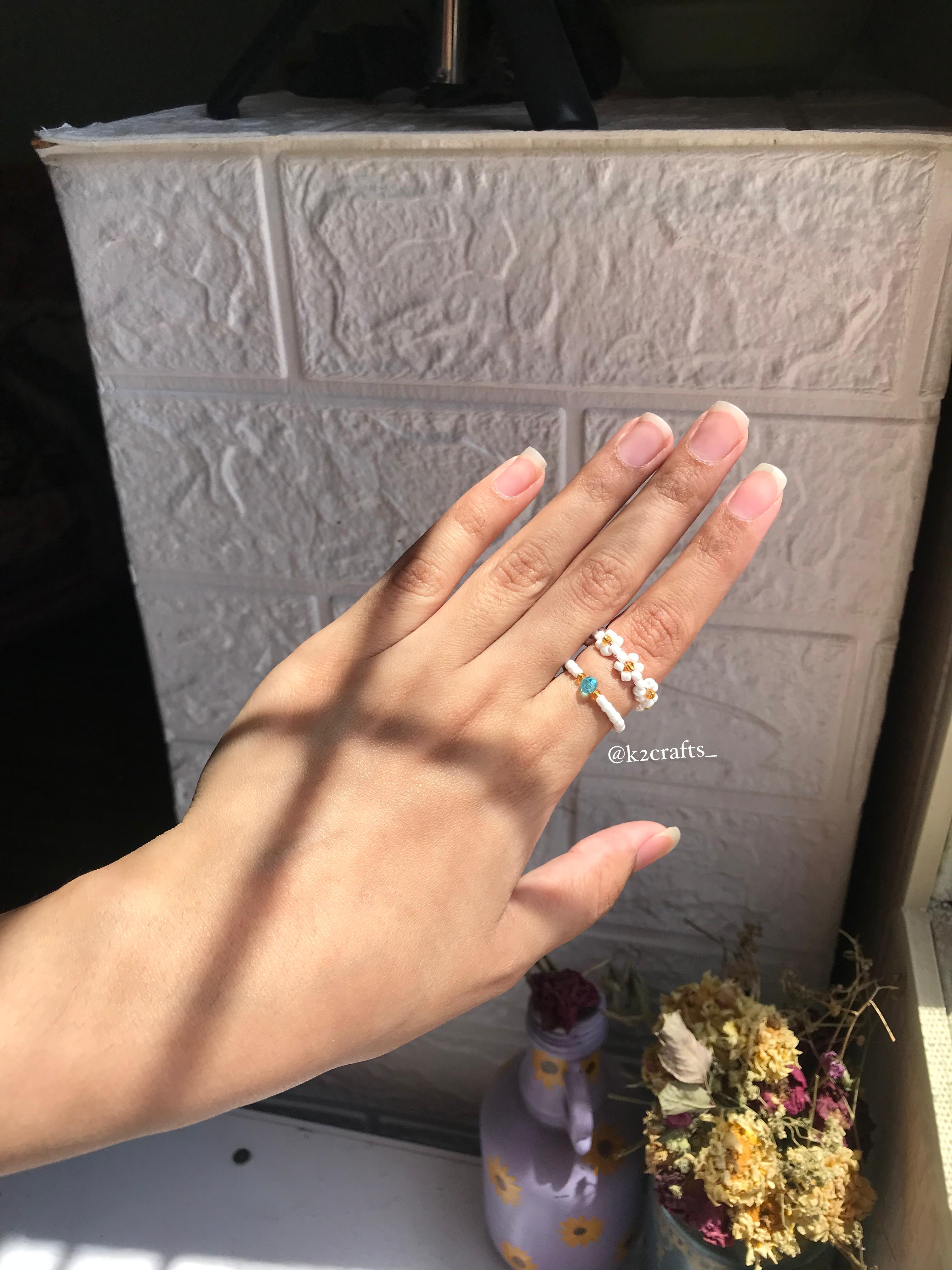 White daisy ring paired with blue crystal ring