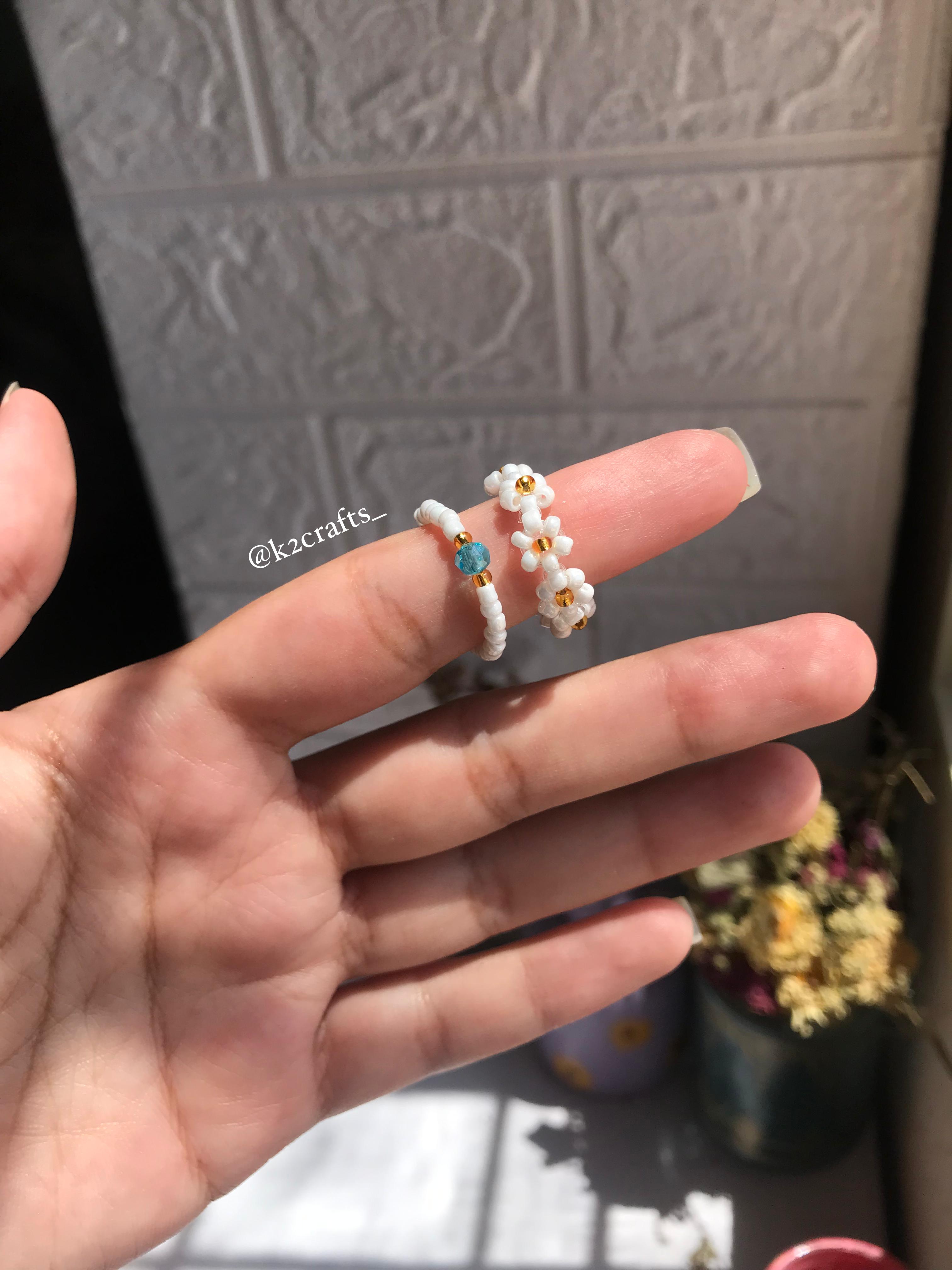 White daisy ring paired with blue crystal ring