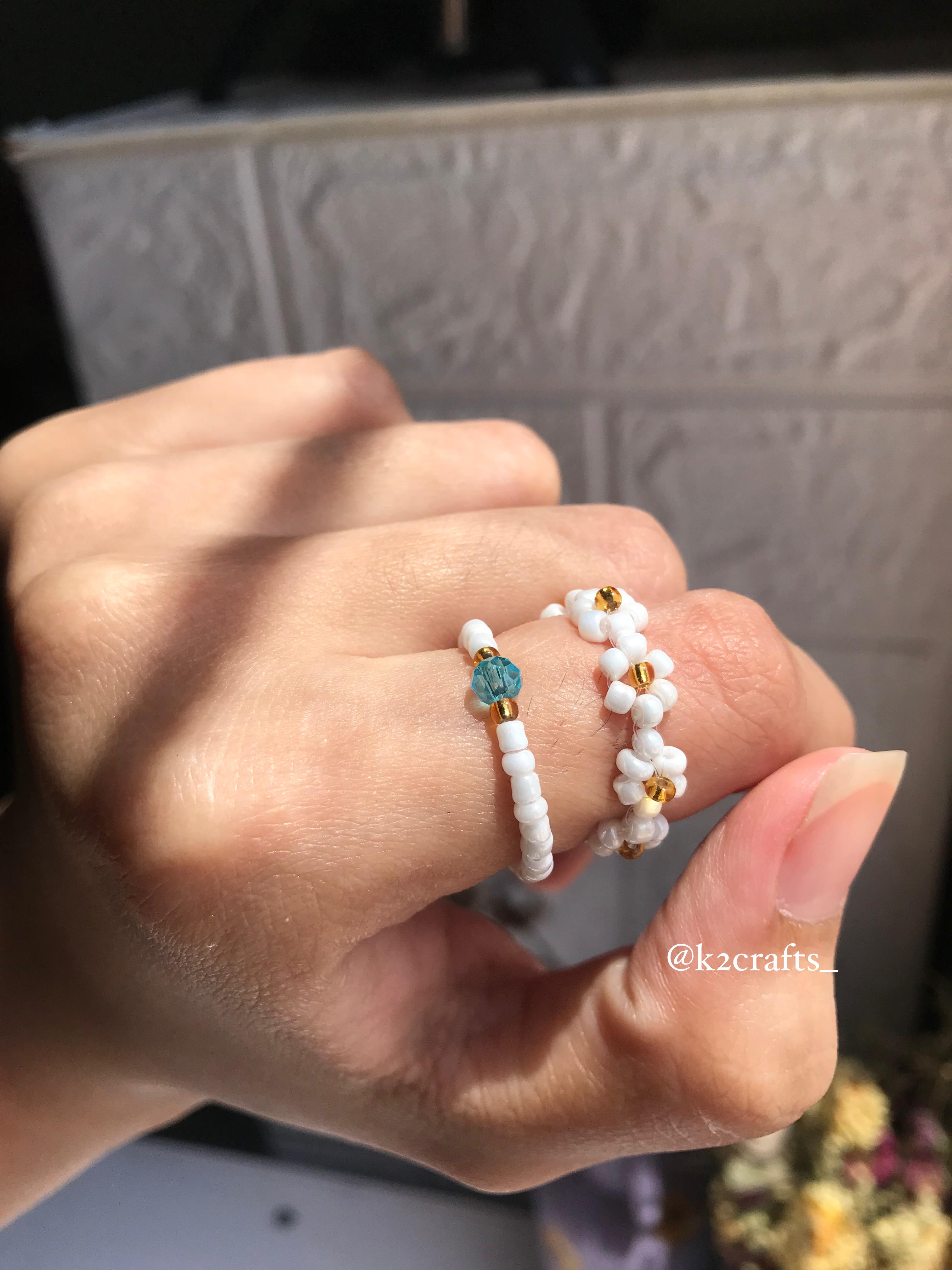 White daisy ring paired with blue crystal ring