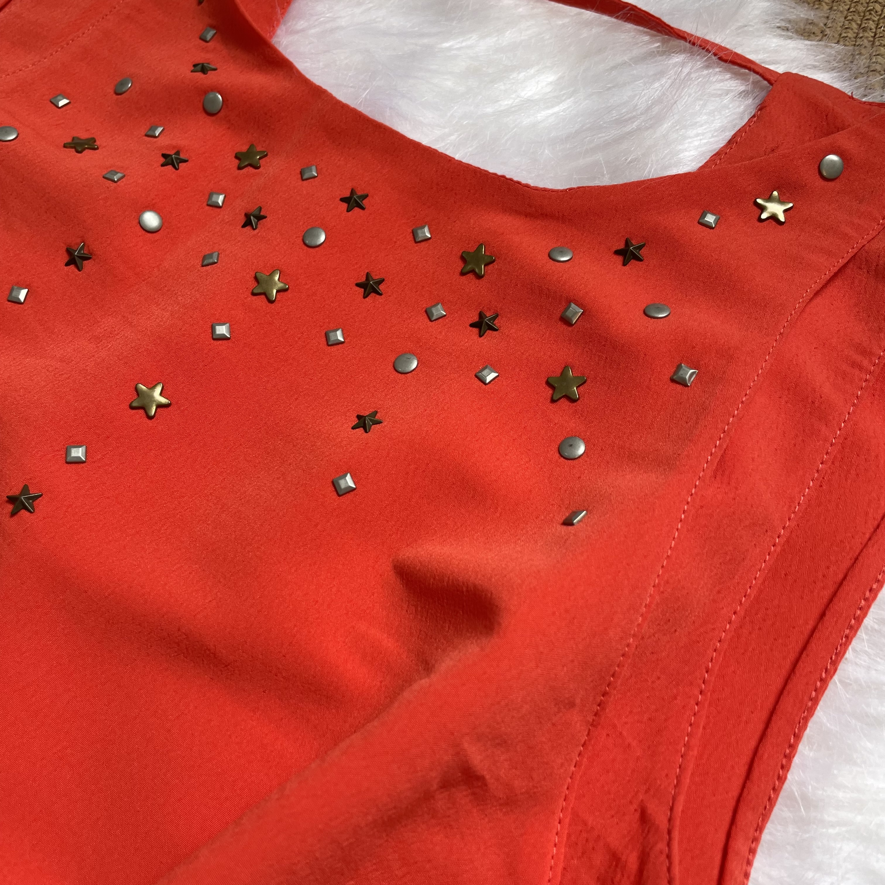 Blusa Laranja com detalhes de estrelas Tamanho P forma grande