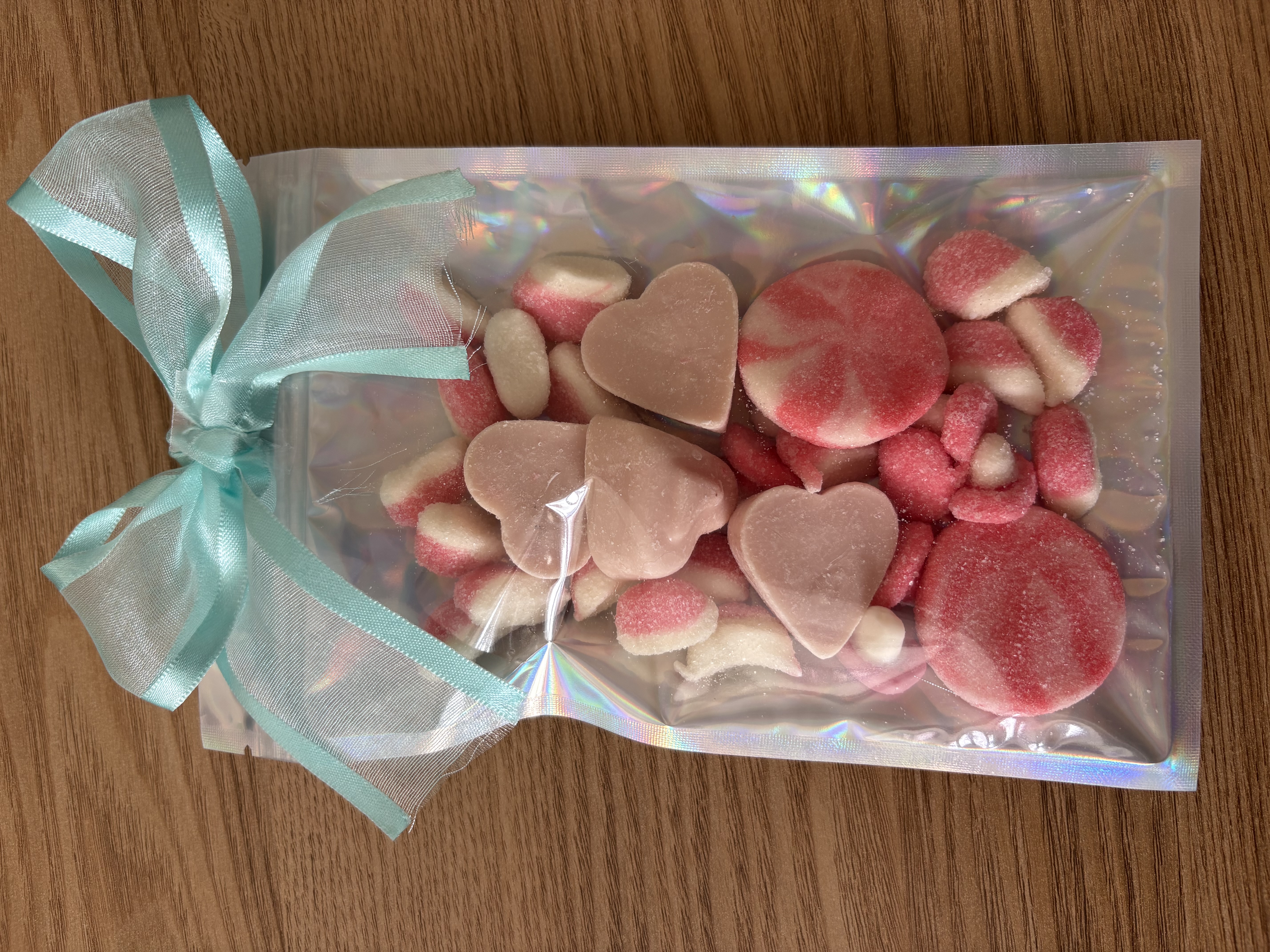 Large holographic sweet pouch eith a variety of sweets and a beautiful ribbon to the top.