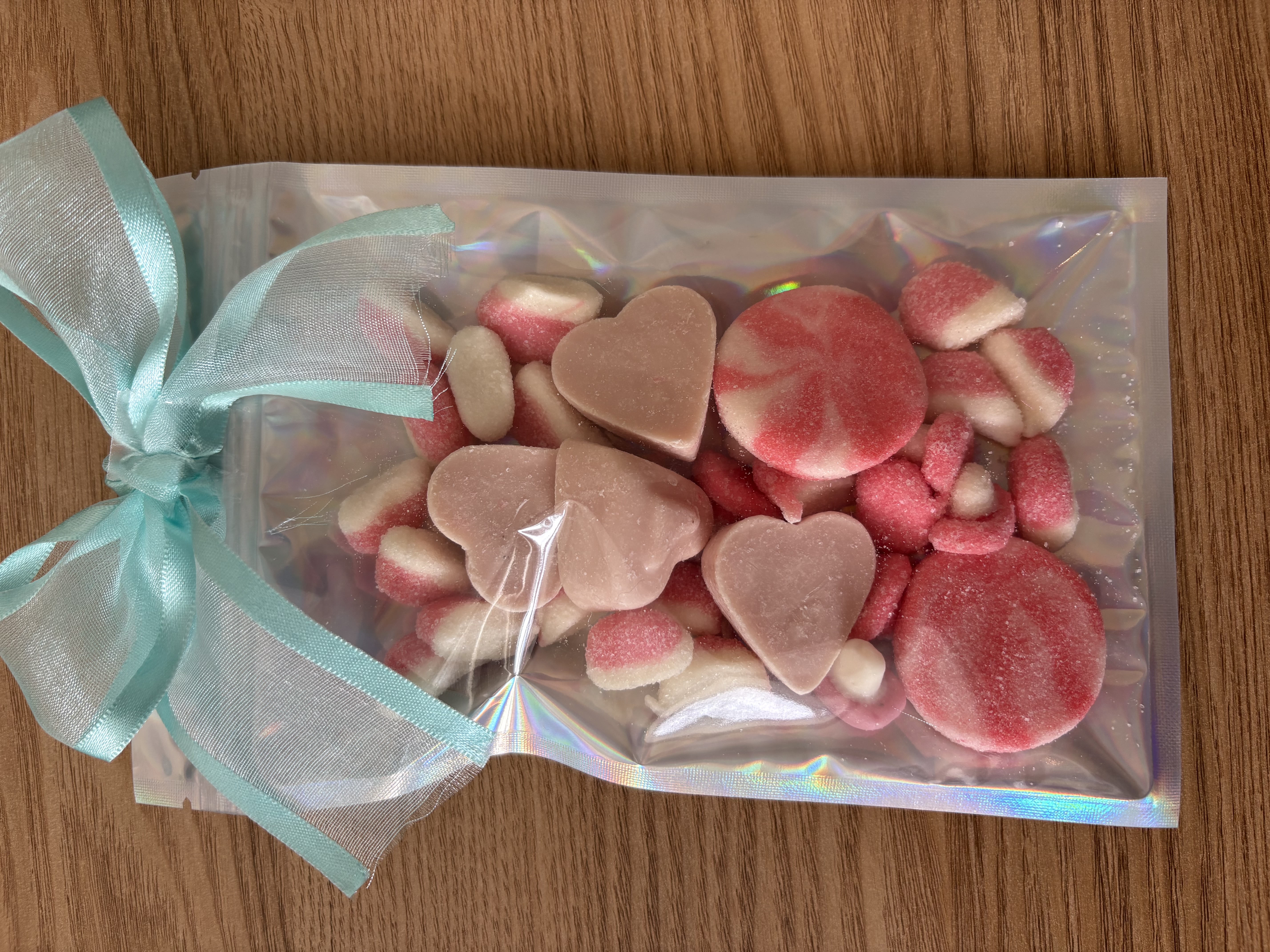 Large holographic sweet pouch eith a variety of sweets and a beautiful ribbon to the top.