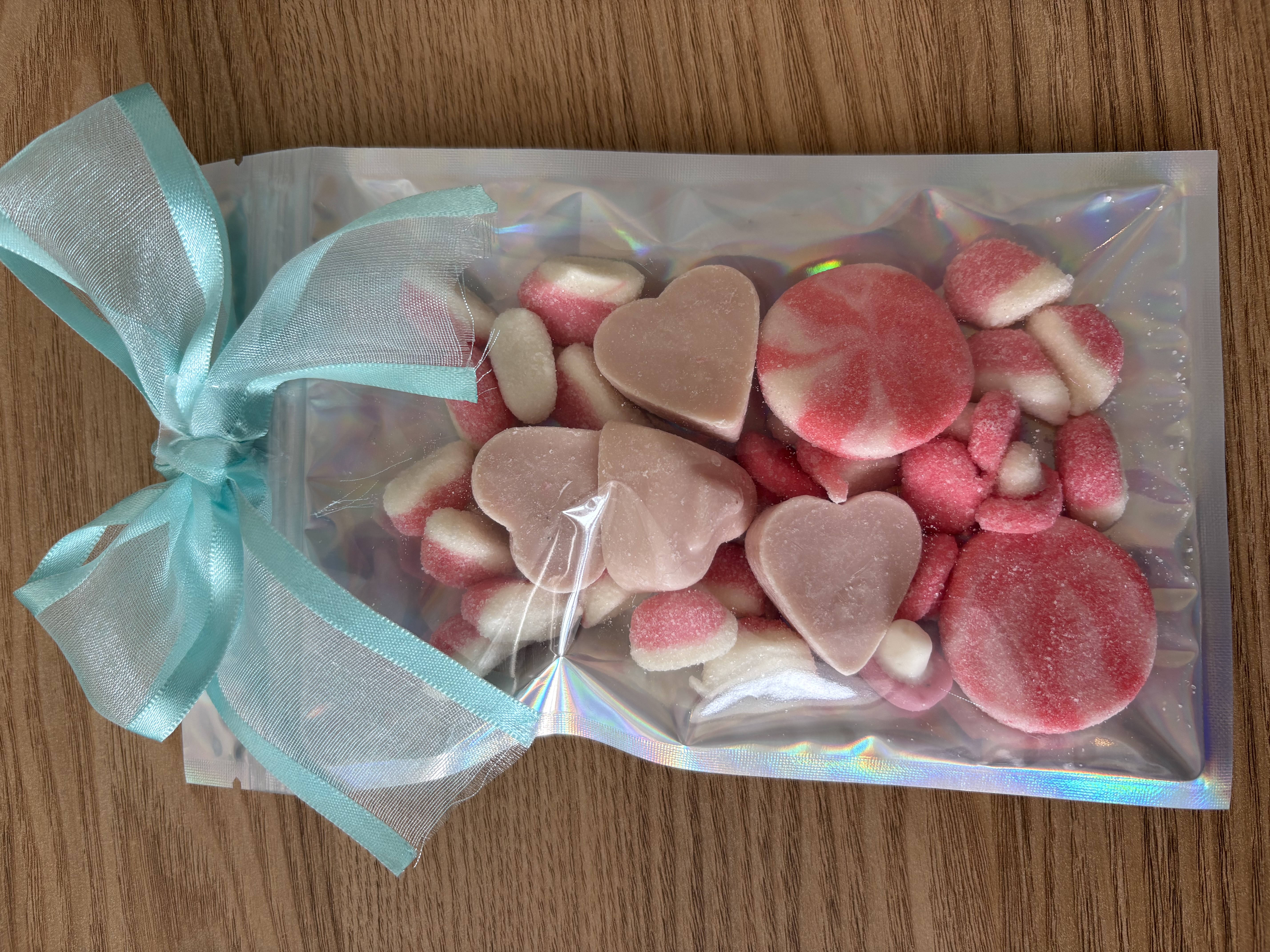 Large holographic sweet pouch eith a variety of sweets and a beautiful ribbon to the top.