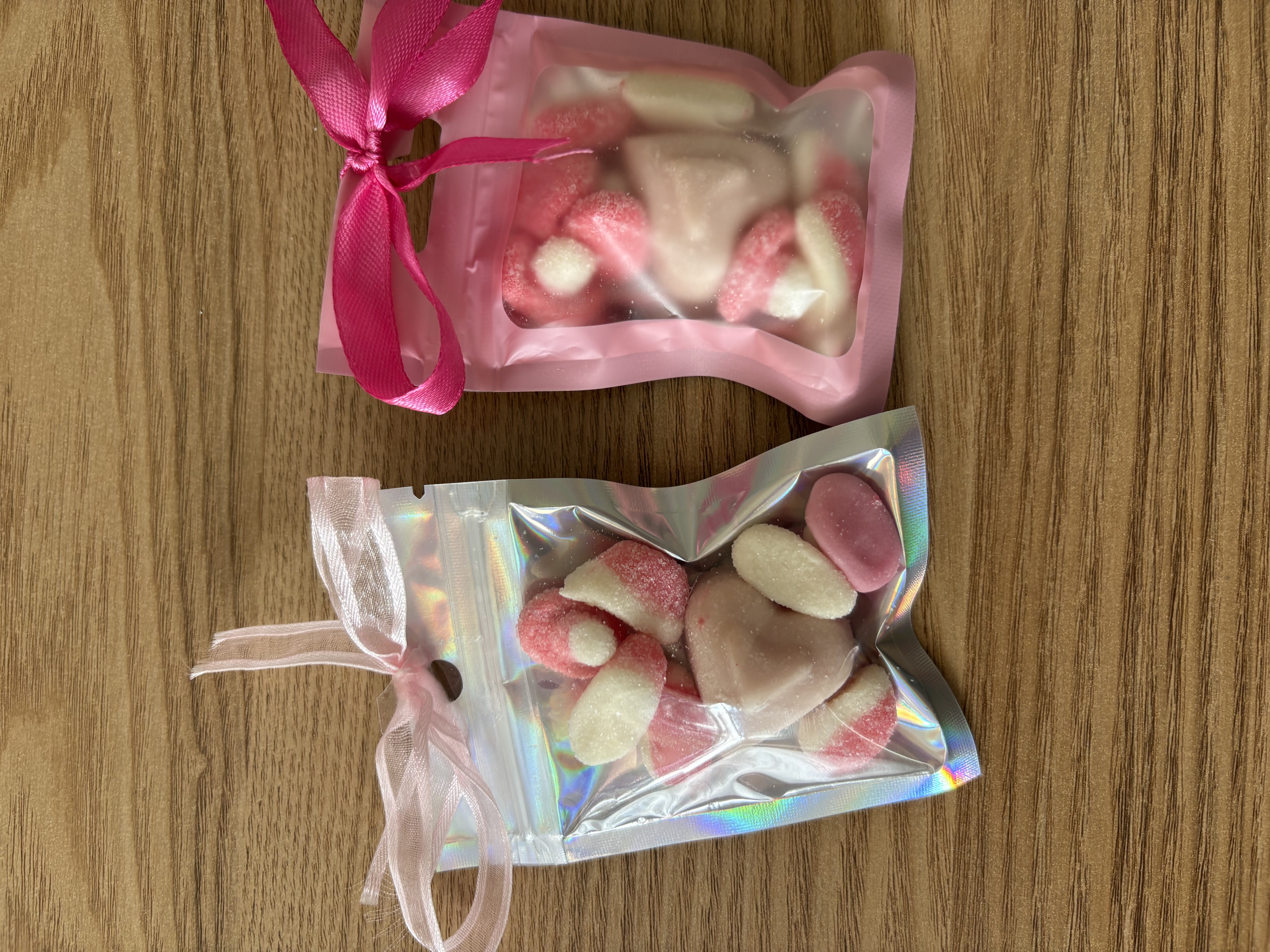 Mini sweet pouches with sweets and ribbon to the top
