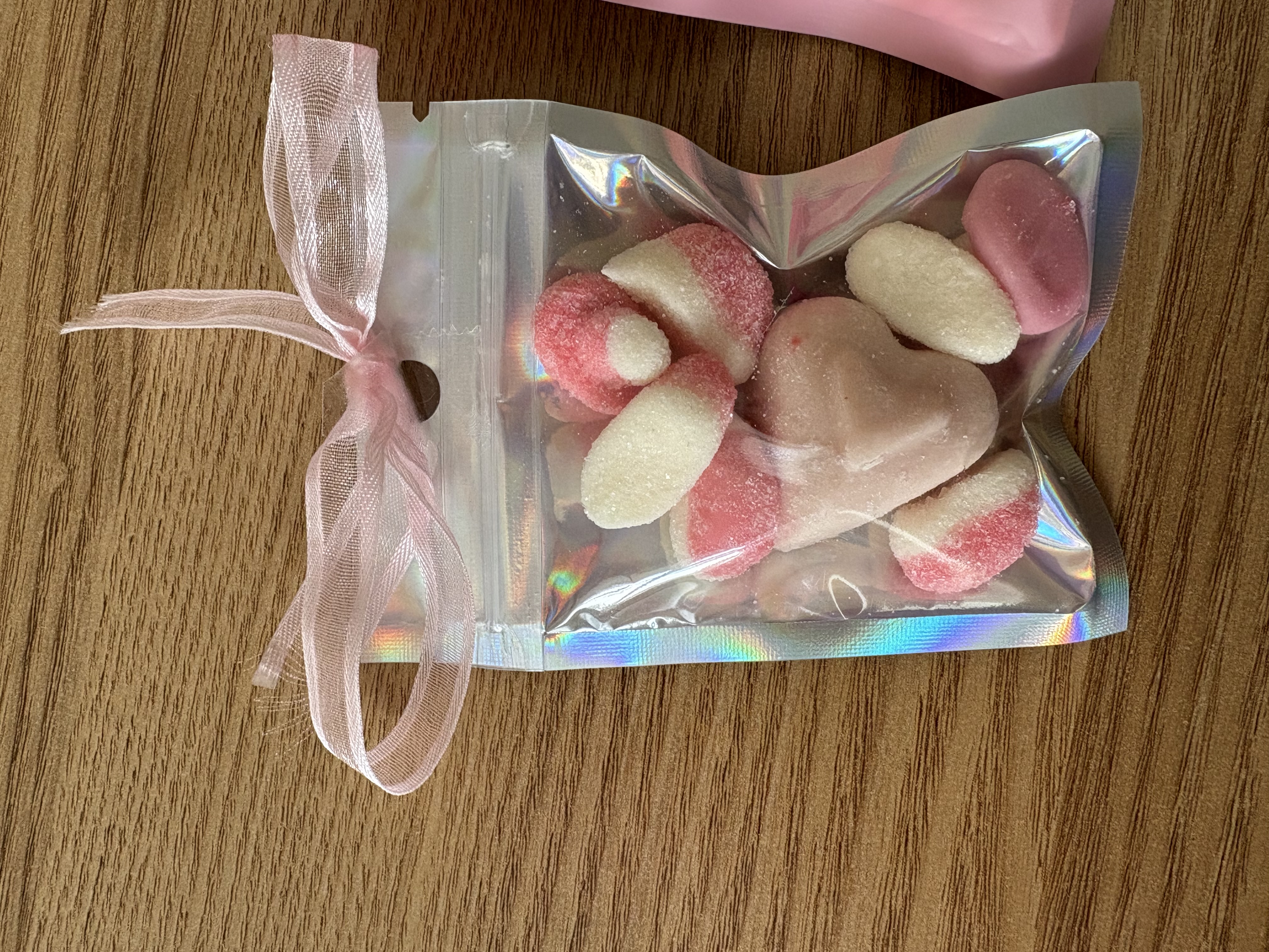 Mini sweet pouches with sweets and ribbon to the top